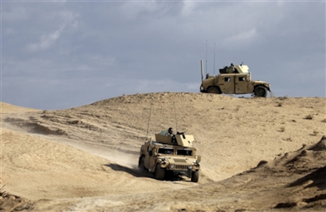 A U.S. Army security team from Charlie Company, 2nd Battalion, 27th Infantry Regiment, 25th Infantry Division sets up a traffic control point during an operation near the village of Abd al Aziz, Iraq, on Nov. 15, 2006.  