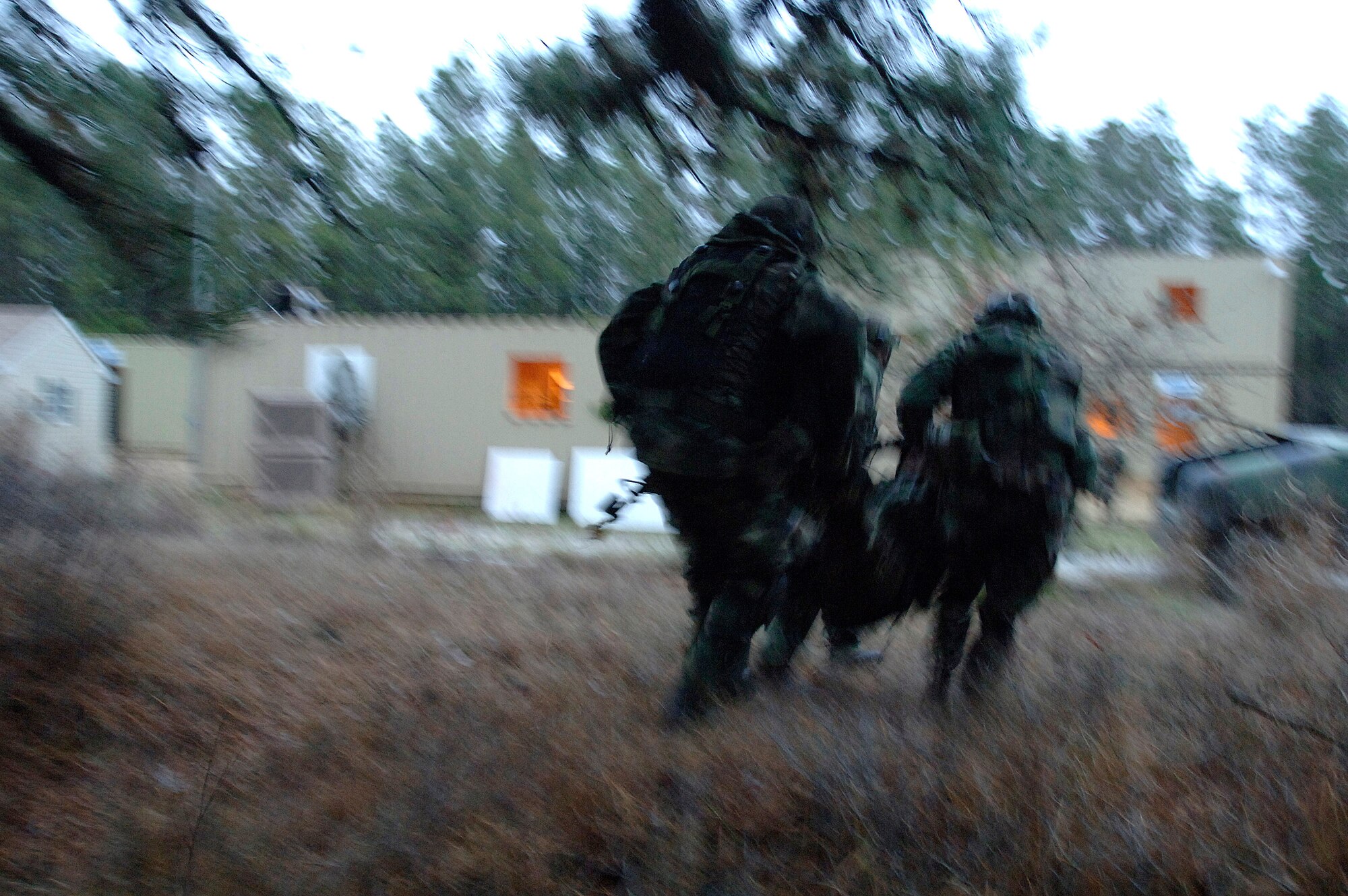 Airmen carry a simulated injured servicemember to safety while taking fire from role-playing insurgents during the Contingency Skills Training course at the Air Mobility Warfare Center at Fort Dix, N.J., Nov. 14. (U.S. Air Force photo/Tech. Sgt. Cecilio M. Ricardo Jr.)
