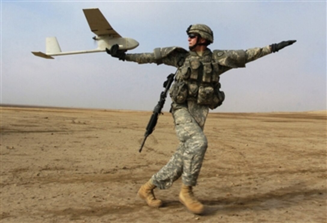 U.S. Army Sgt. Dane Phelps launches a Raven small unmanned aerial vehicle during a joint U.S. and Iraqi cordon and search operation near Kirkuk, Iraq, Nov. 16, 2006. Phelps is assigned to the 2nd Battalion, 27th Infantry Regiment. 