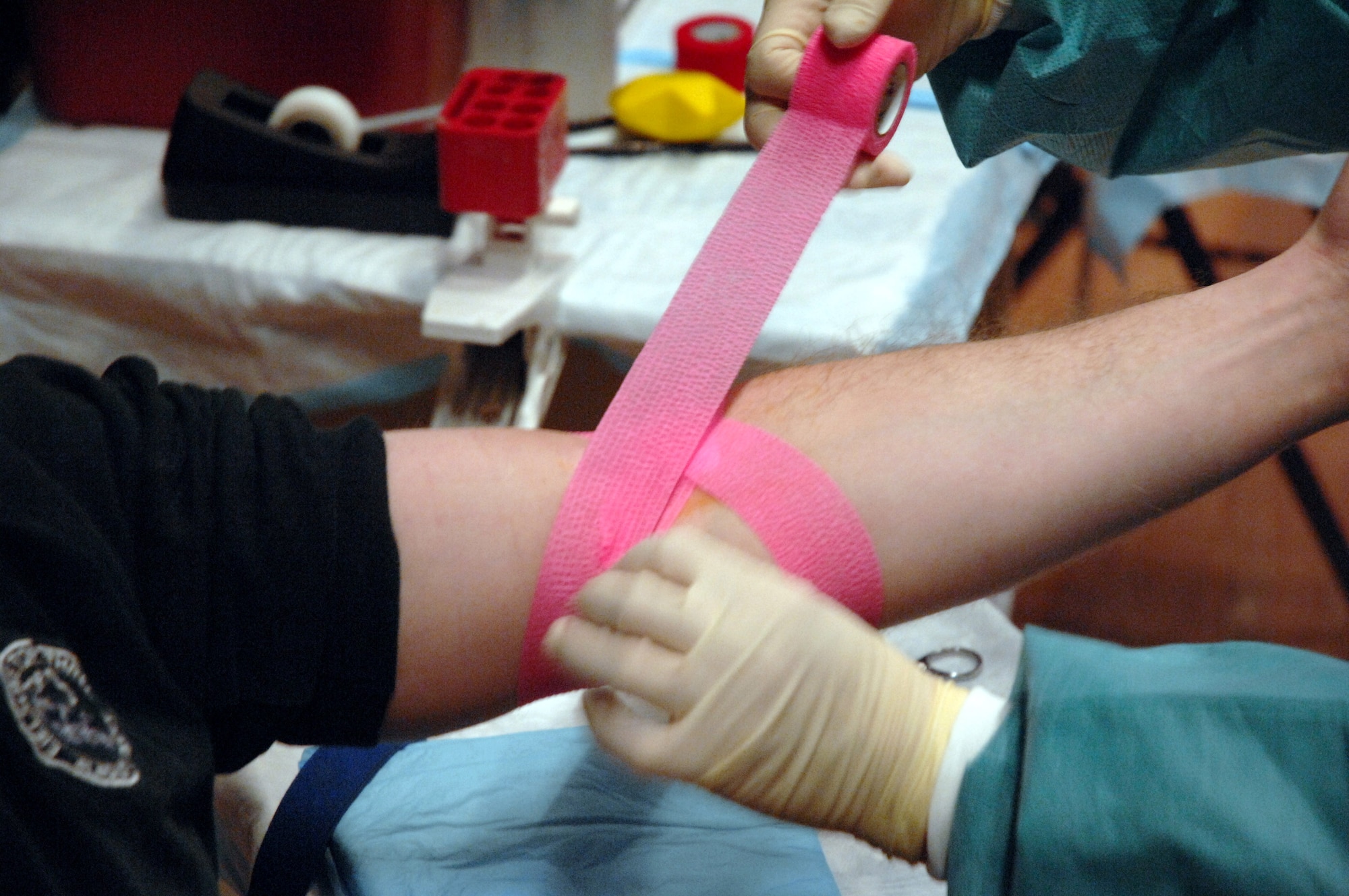 Master Sgt Troy Baird gets the mark of honor as a member of the Blood Bank of Alaska covers the spot where he gave blood during the mobile blood drive Nov. 21 at Eielson Air Force Base, Alaska. The Blood Bank of Alaska supplies blood to military and civilian hospitals throughout Alaska. Sergeant Baird is with the 354th Communications Squadron. (U.S. Air Force photo/Staff Sgt. Joshua Strang)
