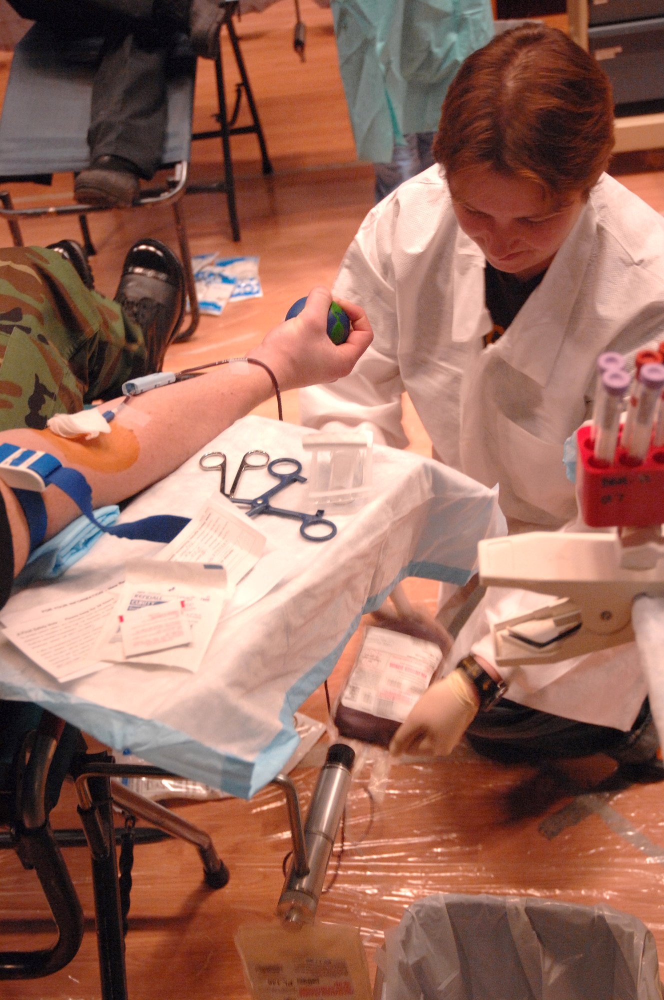 Susan Baker, manager of Blood Bank of Alaska Fairbanks Center, checks the blood collection of Airman Kyle Kremer during the Blood Bank's mobile blood drive Nov. 21 at Eielson Air Force Base, Alaska. The Blood Bank of Alaska supplies blood to military and civilian hospitals throughout Alaska. Airman Kremer is with the 354th Medical Group. (U.S. Air Force photo/Staff Sgt Joshua Strang)