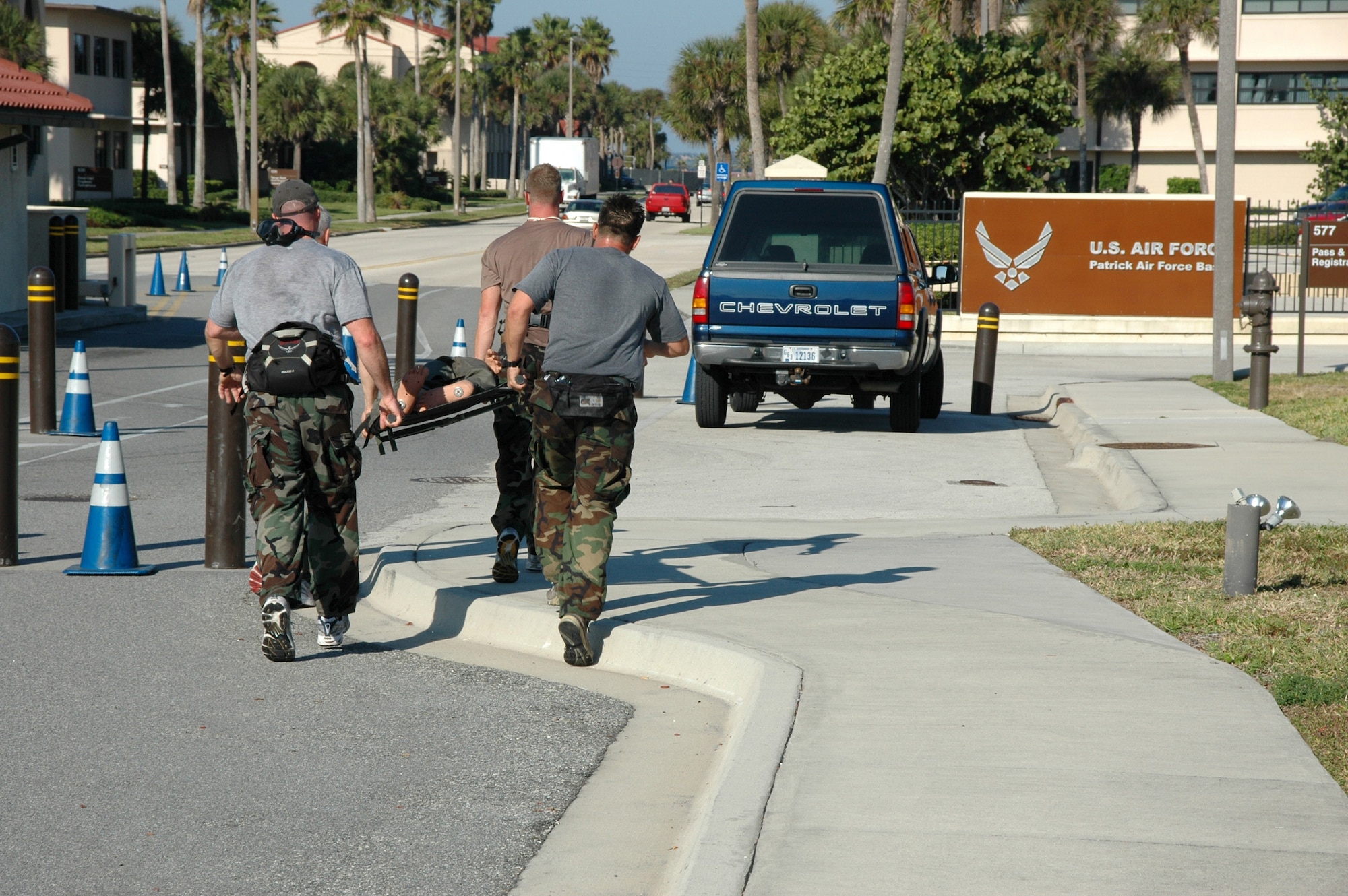 Pararescuemen from the 308th Rescue Squadron sprint through the main gate at Patrick Air Force Base, Fla., while carrying a litter with a 60-pound mannequin during an exercise Nov. 17. (U.S. Air Force photo/1st Lt. Cathleen Snow)
