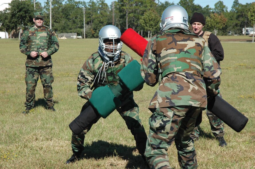 Airmen 1st Class Jeremy Owens (left) and Shawn Roberts (right), 919th Security Forces members, prepare to simulate bayonet fighting with pugil sticks while training under the Marine Corp Martial Arts Program here Nov. 4. The squadron received the training from a MCMAP instructor from Hurlburt Field. (U.S. Air Force Photo/Senior Airman Natasha Eickhoff)