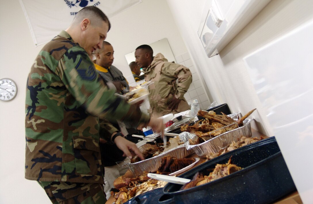 Master Sgt. Carlton Lewis helps himself to some turkey Nov. 23 at a Thanksgiving dinner at the Contingency Air Staging Facility at Ramstein Air Base, Germany. The Germany chapter of The Rough Riders Motorcycle Club provided the meal for the staging facility staff and servicemembers on their way to the United States from deployed locations. (U.S. Air Force photo/Staff Sgt. Dan Bellis)