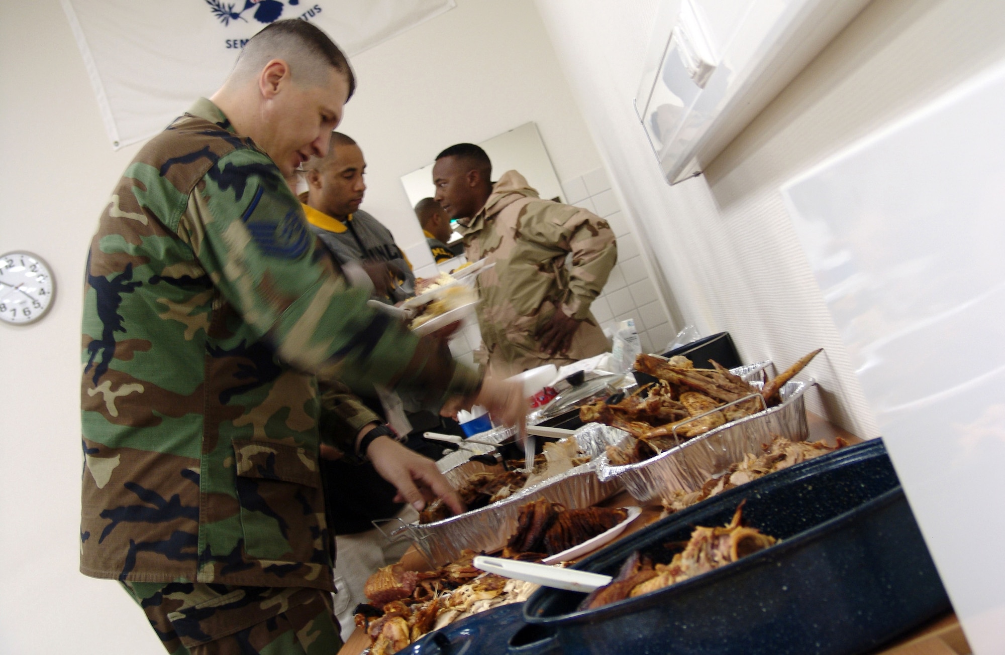 Master Sgt. Carlton Lewis helps himself to some turkey Nov. 23 at a Thanksgiving dinner at the Contingency Air Staging Facility at Ramstein Air Base, Germany. The Germany chapter of The Rough Riders Motorcycle Club provided the meal for the staging facility staff and servicemembers on their way to the United States from deployed locations. (U.S. Air Force photo/Staff Sgt. Dan Bellis)