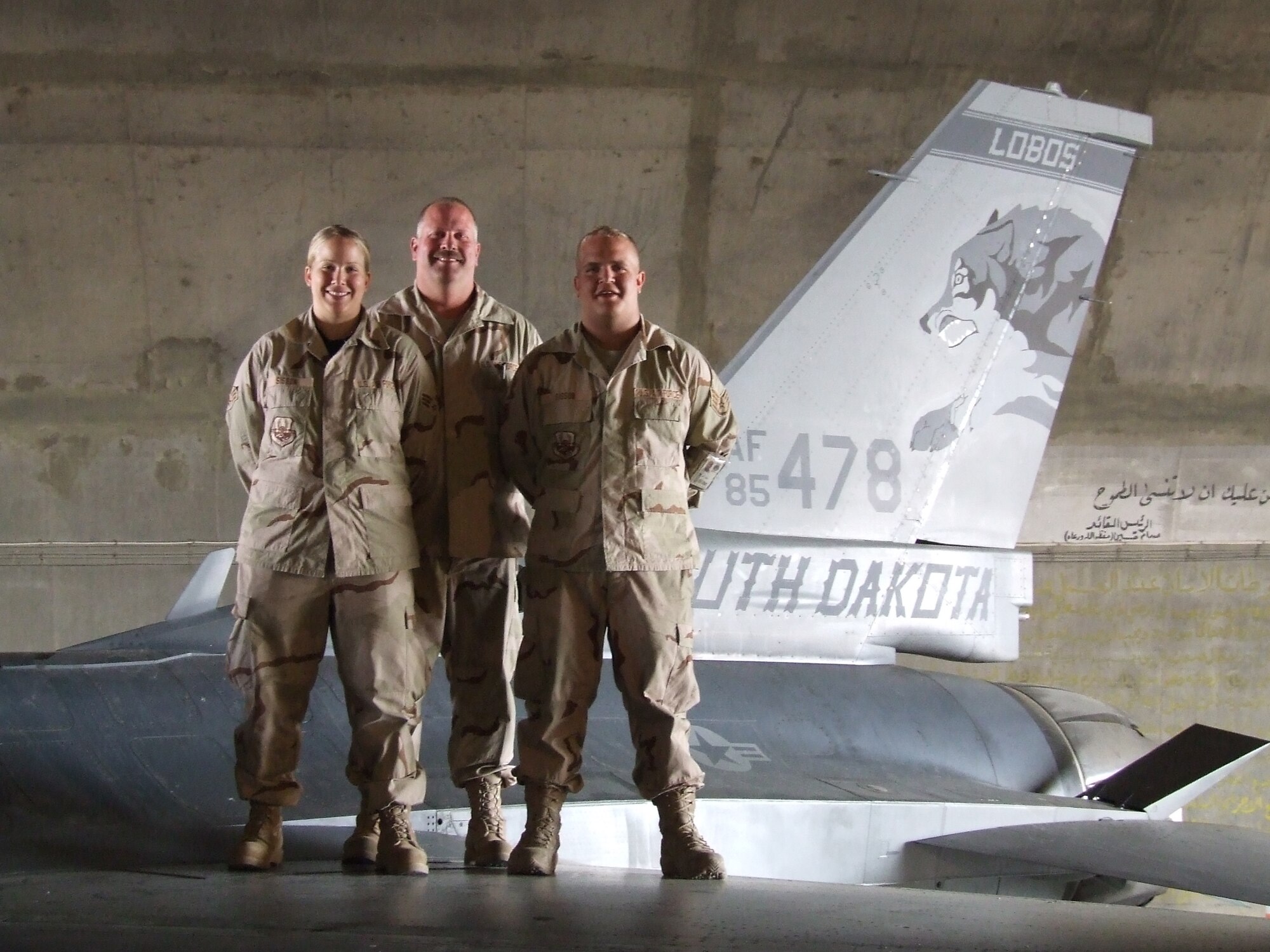 BALAD AIR BASE, Iraq - (From left) Senior Airman Jill Sisson, 332nd Expeditionary Aircraft Maintenance Squadron weapons loader; Senior Master Sgt. Dain Sisson, 332nd Expeditionary Maintenance Group quality assurance inspector; and Staff Sgt. Justin Sisson, 332nd EAMXS crew chief, are deployed to Balad Air Base together from Joe Foss Field, Sioux Falls, S.D. Senior Master Sgt. Sisson is Staff Sergeant and Airman Sisson’s father. (U.S. Air Force photo by Maj. Richard Sater) 
