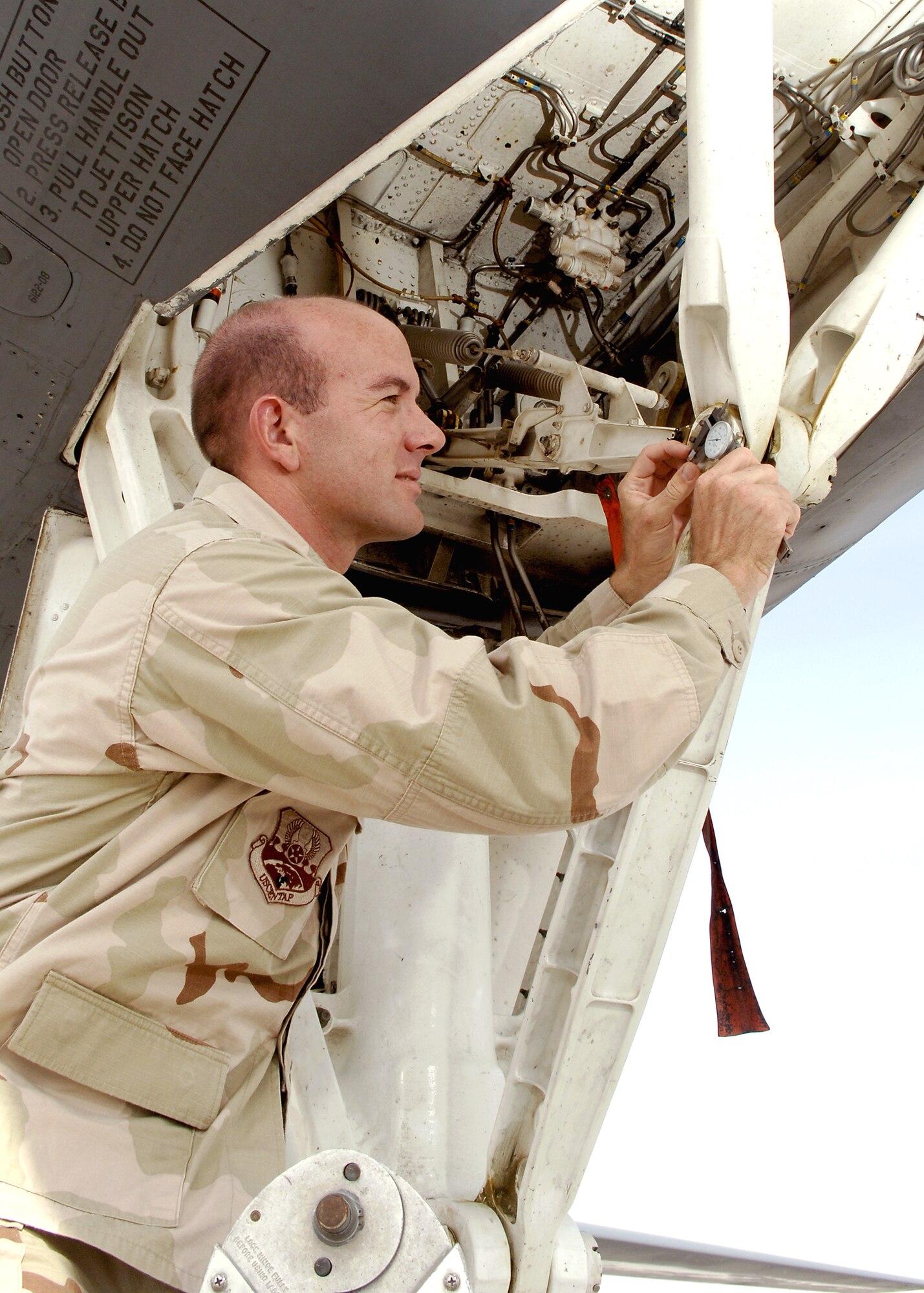 Second Lt. Mark Eilertsen, a depot liaison engineer with the 379th Expeditionary Maintenance Operations Squadron, uses a dial caliper while inspecting the nose landing gear of a B-1 Lancer. (U.S. Air Force photo/Senior Airman Ricky Best) 

