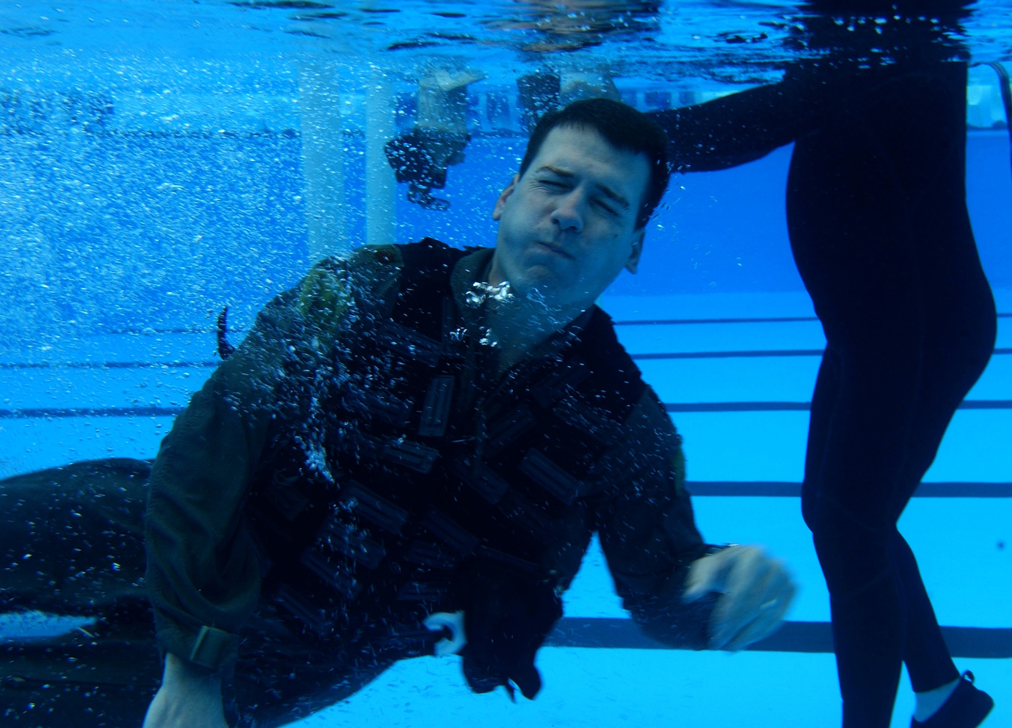 Maj. Ronald Frantz, 76th Helicopter Squadron commander, escapes a mock submerged helicopter at  Nov. 22 at Vandenberg's base pool.  The exercise is used to prepare crew members to safely escape a submerged aircraft and assure crew member recovery afterwards.  (U.S. Air Force photo by Airman Adam Guy)                               