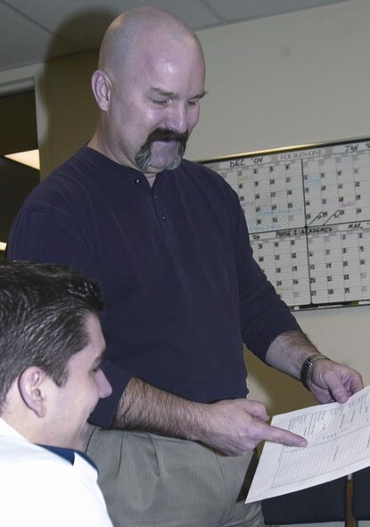 (Photo by Frank McIntyre) Gene Kornman, 71st Operations Support Squadron school registrar, reviews a schedule with 2nd Lt Matthew Acuff.