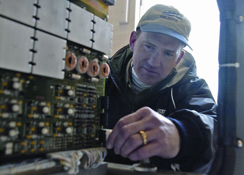 (Photo by TSgt M. Davis) John Barron, FlightSafety International simulation program manager, inspects the cockpit assembly on a T-6 Texan II operational flight trainer Jan. 19. Vance Air Force Base received two of the dome-shaped simulators to train Joint Specialized Undergraduate Pilot Training students.