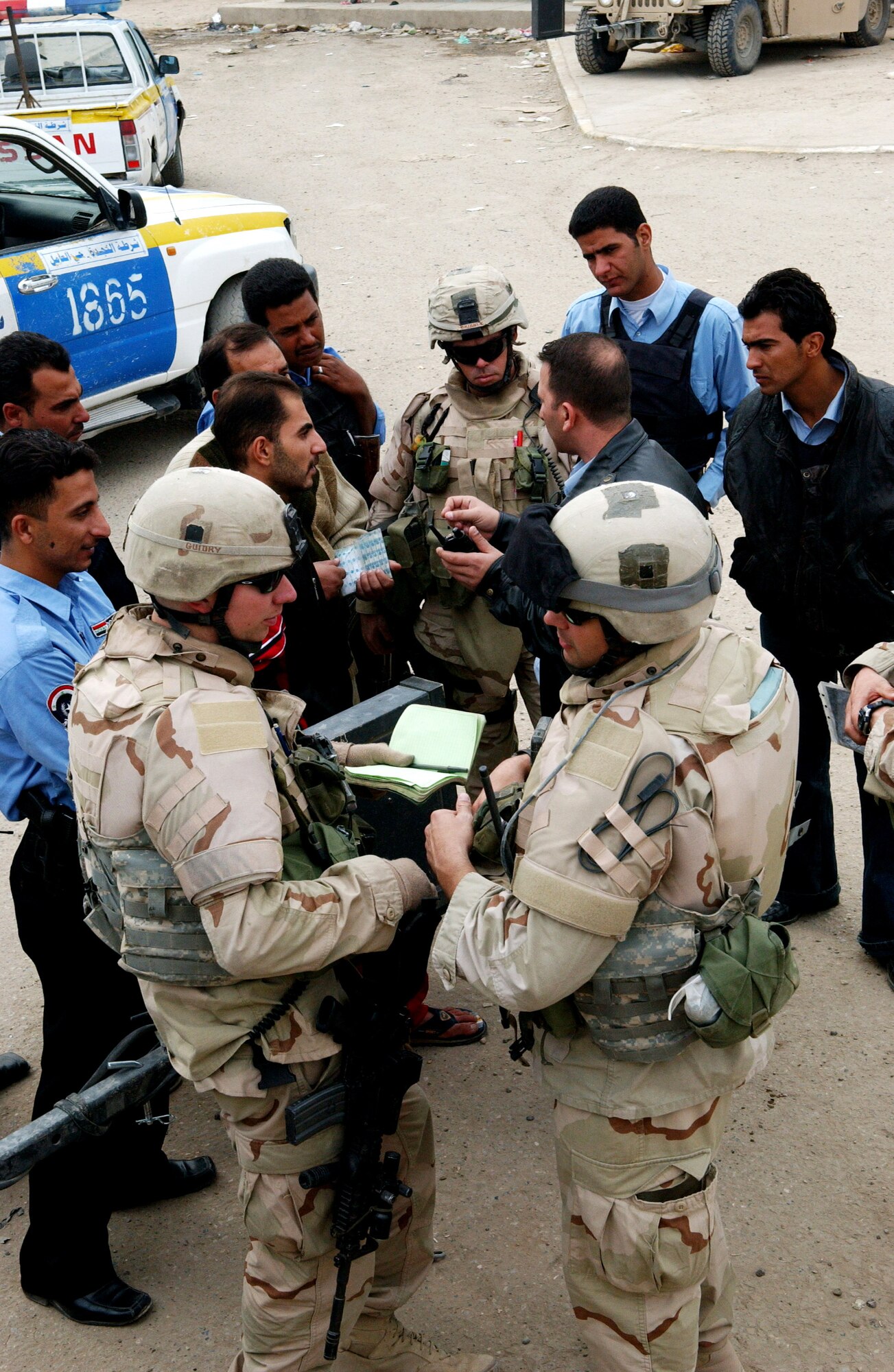 Detachment 7, 732nd Expeditionary Security Forces Squadron Airmen speak with Iraqi policemen Nov. 23 in the Hy Al-Amil district of Baghdad. The squadron's mission is to deploy into the city Baghdad assisting Iraqi police in achieving self-sufficiency. (U.S. Air Force photo/Master Sgt. Steve Cline) 
