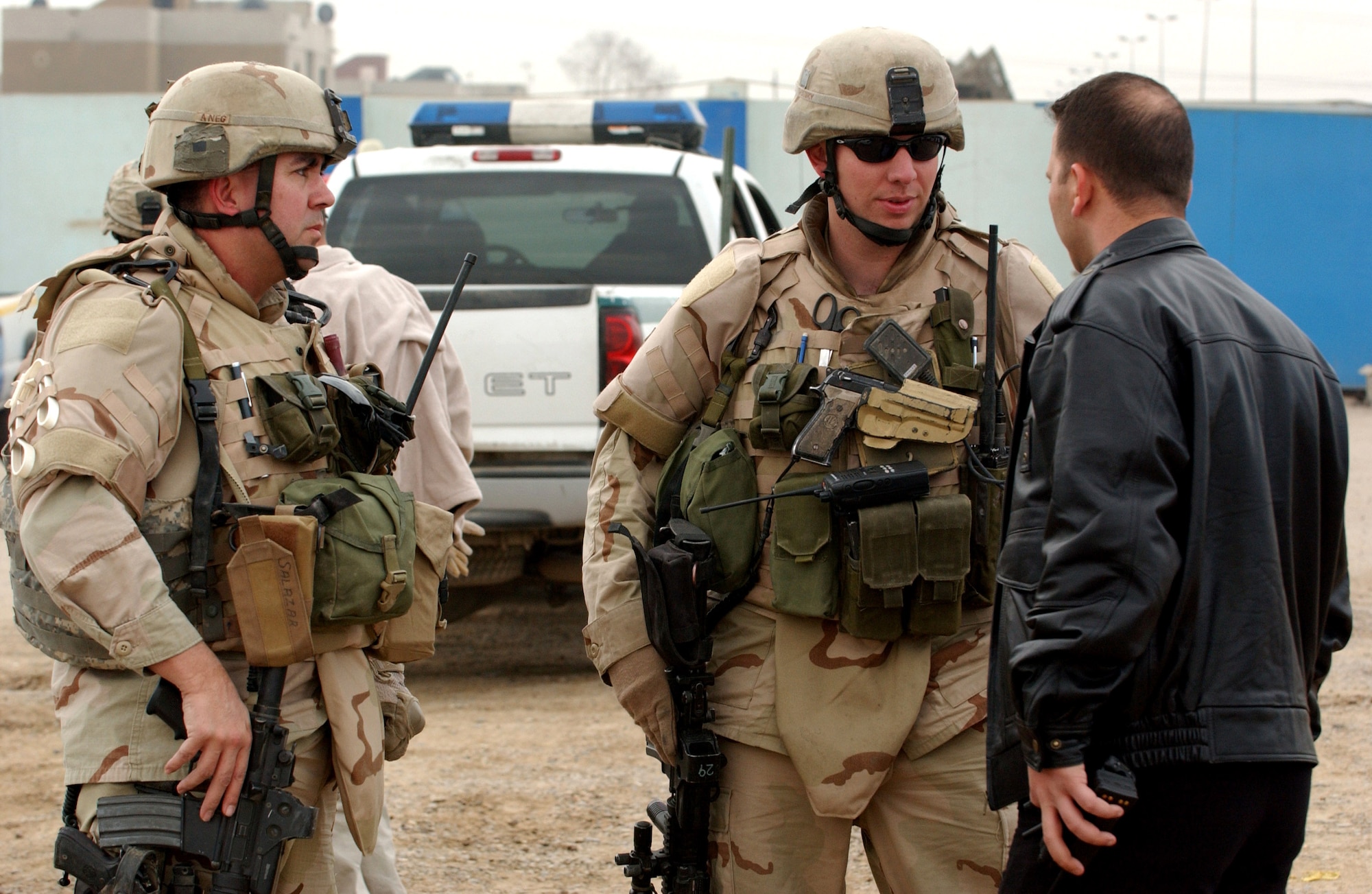 Staff Sgt. James Guidry, center, speaks with an Iraqi policeman Nov. 23in the Hy Al-Amil district of Baghdad, Iraq. Airmen from Detachment 7, 732nd Expeditionary Security Forces Squadron deploy into the city streets of Baghdad assisting Iraqi police in achieving self-sufficiency. (U.S. Air Force photo/Master Sgt. Steve Cline)
