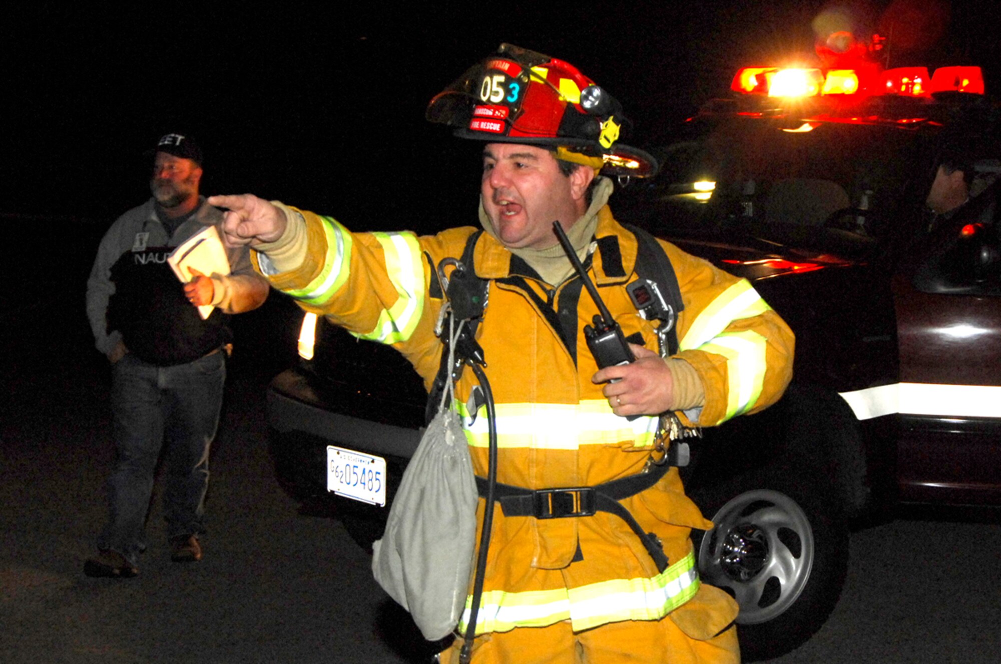 Capt. Dominic Camilli, Hanscom Fire Department, directs first responders at the site of a simulated hazardous materials incident during the base readiness exercise Nov. 20. (Photo by Mark Wyatt)