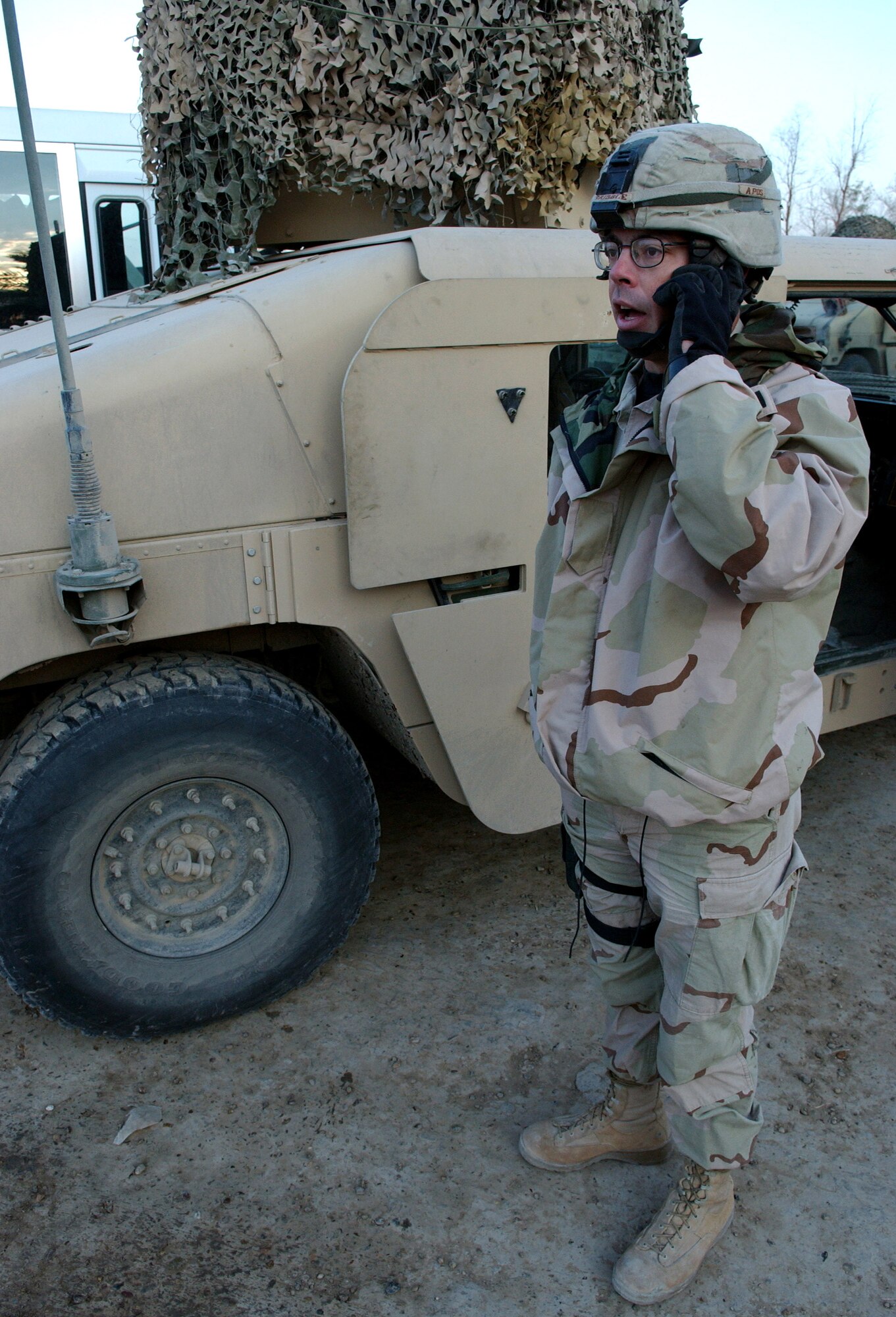 Tech. Sgt. Gene Gribble speaks to his squadron headquarters prior to a patrol Nov. 23 in Baghdad, Iraq. Sergeant Gribble is a squad leader with Detachment 7, 732nd Expeditionary Security Forces Squadron, and its mission is to deploy into the city streets of Baghdad assisting Iraqi police in achieving self-sufficiency. (U.S. Air Force photo/Master Sgt. Steve Cline)