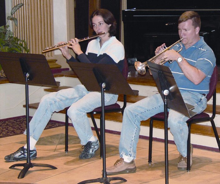 (Photo by 2nd Lt. James Justice) Cindy Jones, wife of Master Sgt. David Jones, 71st Operations Support Squadron, and Capt. Fred Deakins, 71st Operations Group, get a little rehearsal time in with the Enid Symphony Orchestra in preparation for this weekend’s series opener.