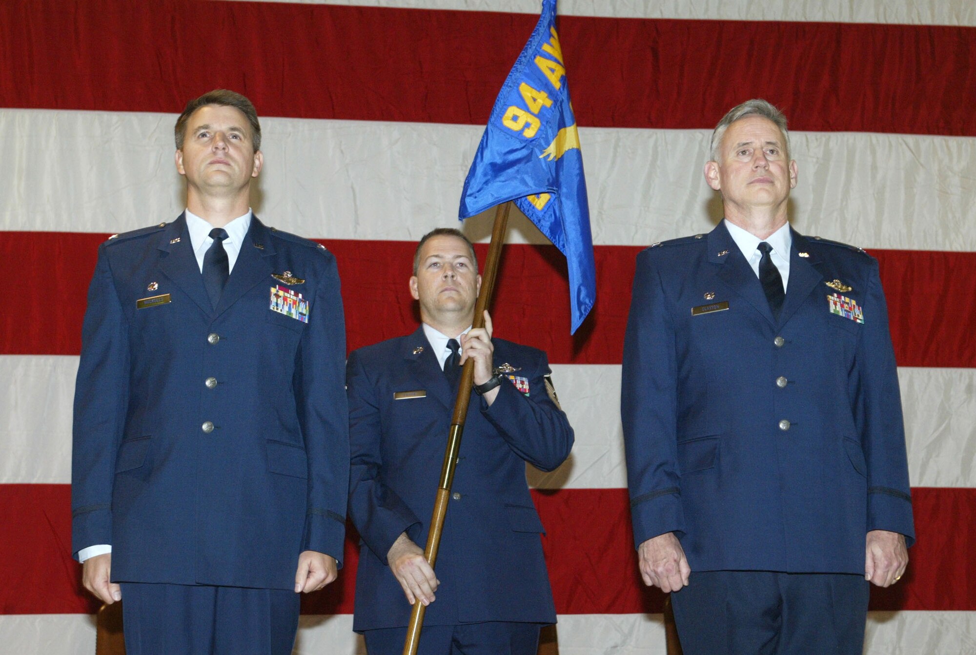 Col. Heath Nuckolls, 94th Airlift Wing commander, left, presents command of the 94th Operations Group to Col. Steve Clayton, right, during an official assumption of command ceremony here Nov. 5.