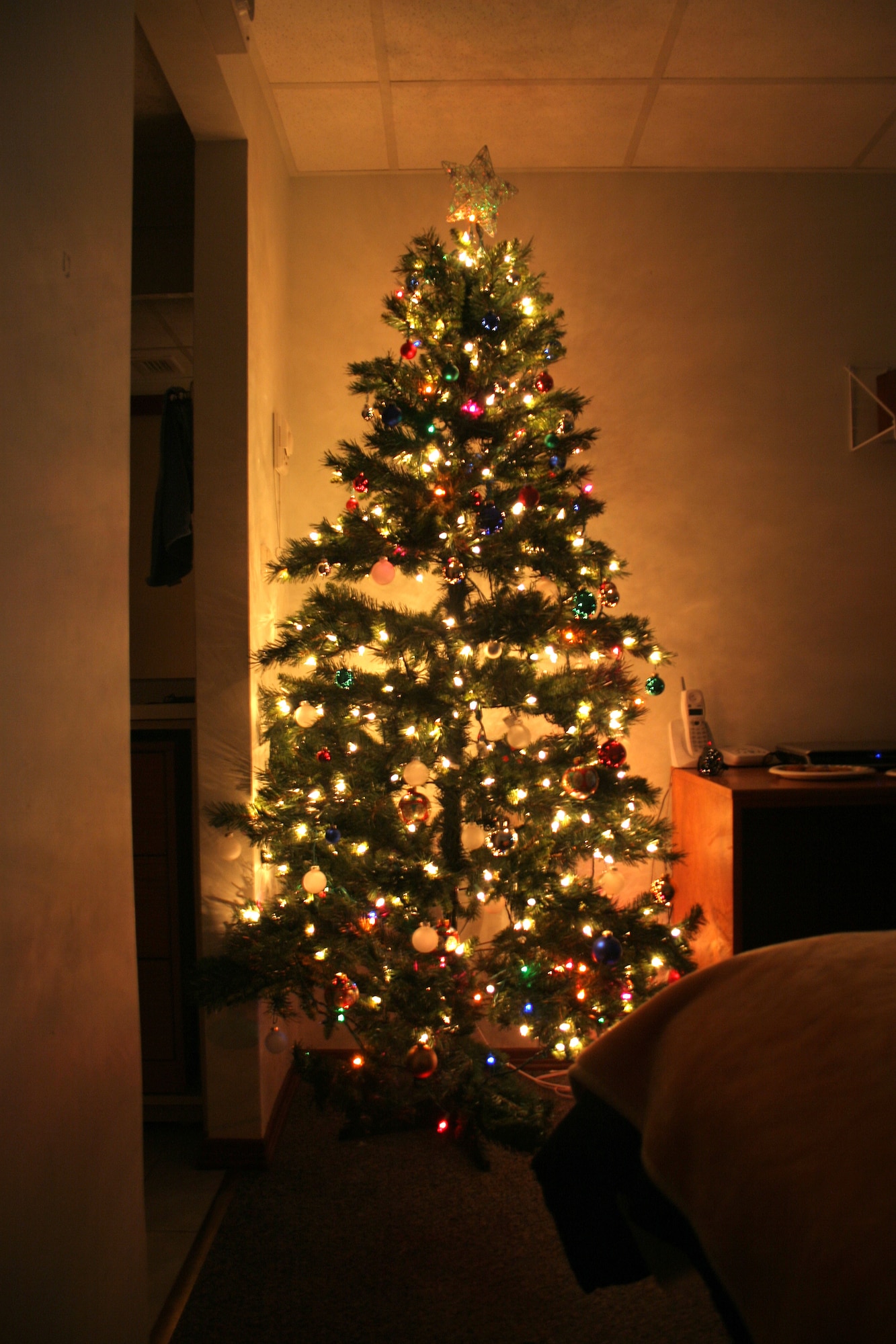 Fire prevention rules for Christmas trees: A dried-out evergreen tree is an extremely dangerous fire hazard. Buy a freshly cut tree; beware of any tree with brittle or shedding needles. Stand the tree on a sturdy, non-trip tree stand; keep it away from heat sources, such as radiators, television sets and fireplaces. Ensure it does not block room exits. Do not put it in front of balcony doors, this is a second means of escape. Check the water level daily; discard the tree when the water absorption stops. When purchasing an artificial tree, be sure it is labeled as “fire-retardant.” (U.S. Air Force photo by Senior Airman Tim Beckham)