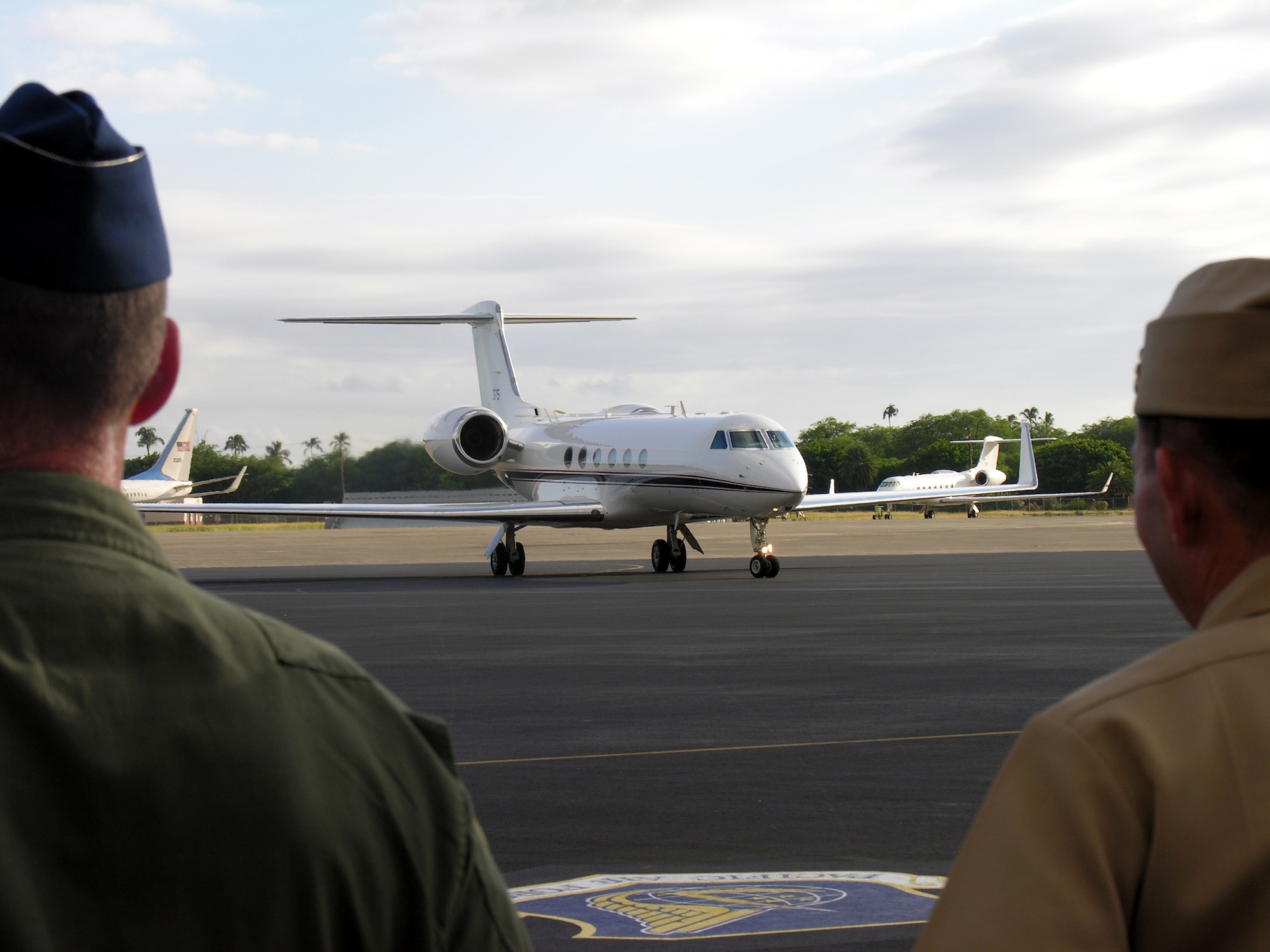 HICKAM AIR FORCE BASE, Hawaii -- Air Force and Navy members greet the Pacific Fleet’s C-37A upon its arrival here November 18.  The plane will be used to transport Admiral Gary Roughead, Pacific Fleet Commander.  The plane will be housed on Hickam, as  well as the Navy’s Executive Transport Detachment – Pacific and will work with the Air Force's 65th Airlift Squadron who fly similar planes for the Pacific Command and Pacific Air Forces commanders.  (Official Air Force Photo by Senior Airman Erin Smith)