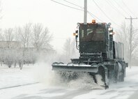 MINOT AIR FORCE BASE, N.D. -- A 5th Civil Engineer Squadron snowplow clears a road here Nov. 28, 2006. Minot received a mix of snow and rain, which made for unfavorable driving conditions. (U.S. Air Force photo by A1C Christopher Boitz)  (U.S. Air Force photo by Airman 1st Class Christopher Boitz) 