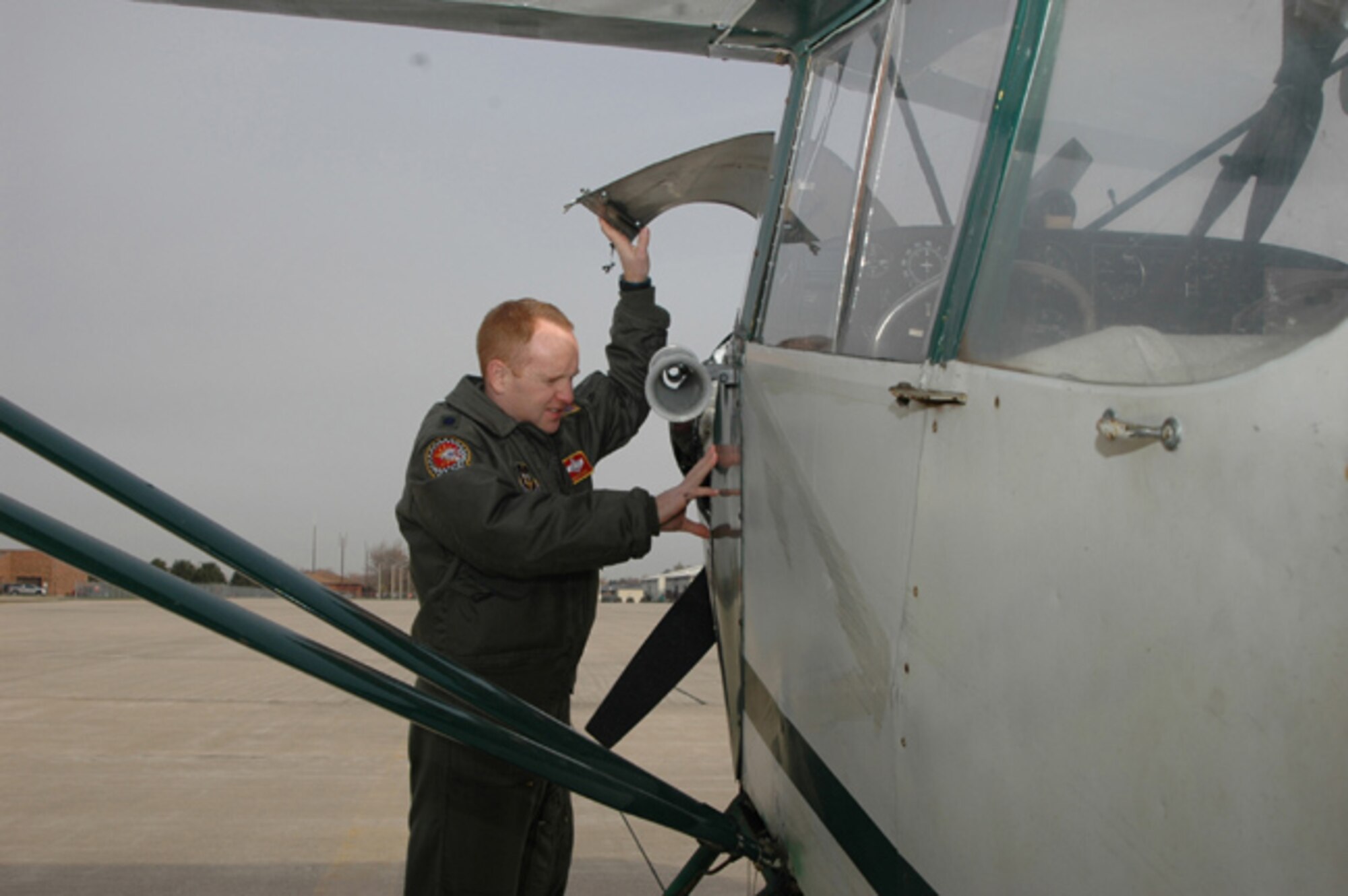 GRISSOM AIR RESERVE BASE, Ind. -- Lt. Col. Kevin Hayes, a pilot with the 74th Air Refueling Squadron,  checks the engine on his private airplane.  The colonel purchased the aircraft in Alaska and now uses it to commute from his home in Illinois to Grissom ARB. (U.S. Air Force photo/Senior Airman Chris Bolen) 