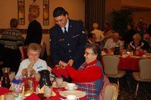 MINOT AIR FORCE BASE, N.D. -- Airman 1st Class Steven Durbin, 5th Civil Engineer Squadron, offers muffins to guests during Minot Air Force Base’s annual “Day of Love” Nov. 23. For nearly 40 years the base has hosted the special event, which connects Airmen volunteers with Minot senior citizens to spend Thanksgiving together. (U.S. Air Force photo by Airman 1st Class Joe Rivera)