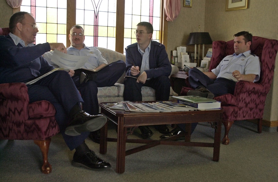 (Photo by Staff Sgt. Amanda Mills) Chaplain (Lt. Col.) Steven Nicolai, Tech. Sgt. Timothy Storer, Senior Airman Stephen Huffman and Chaplain (Capt.) Samuel Bridges, review planning for future chapel activities.