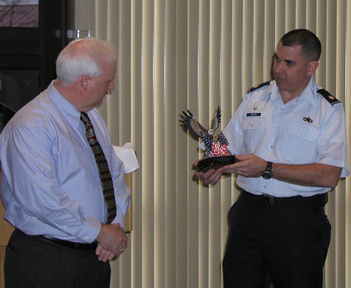 (Photo by Bob Farrell) Kip Miles, 2004 71st Comptroller Squadron honorary commander, accepts a memento from Maj. Mike Wilson, 71st CPTS commander, during the squadron’s honorary change of command ceremony Tuesday.