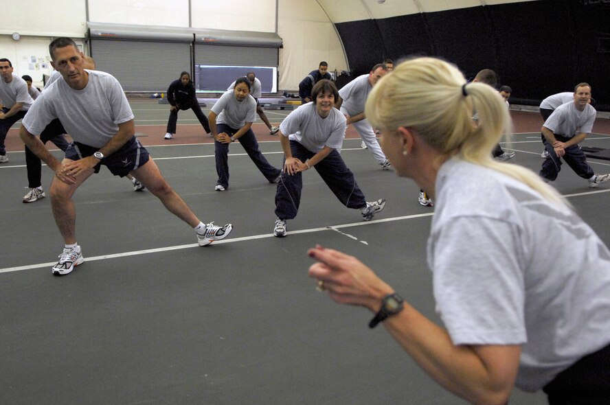Chief Hake, far left, front row, exercises beside 66th Air Base Wing and Electronic Systems Center Command Chief Master Sgt. Lisa Sirois and members of the 653rd Electronic Systems Group during a physical training session led by 653 ELSG Commander Col. Anita Latin Tuesday morning in the Tennis Bubble. Photo by Mark Wyatt

