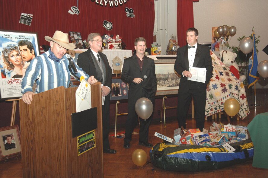 FAIRCHILD AIR FORCE BASE, Wash. -- George Maupin, Matt Rodgers, and Dave Cotton from KHQ TV Channel 6 join Fairchild members as they support “celebrity night” Nov. 18 at a live auction held in order to raise money for operating funds for the Officer’s Spouse’s Club and its scholarships. This event is held yearly at Club Fairchild.  (U.S. Air Force photo/Senior Airman Jessica Fuentez)
