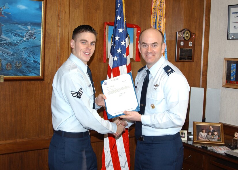(Photo by Terry Wasson) SrA Andrew Heckathorn, 25th Flying Training Squadron, receives a congratulations letter from Col. Mike Callan, 71st Flying Training Wing commander, Wednesday for his acceptance into the Air Force ROTC program. 