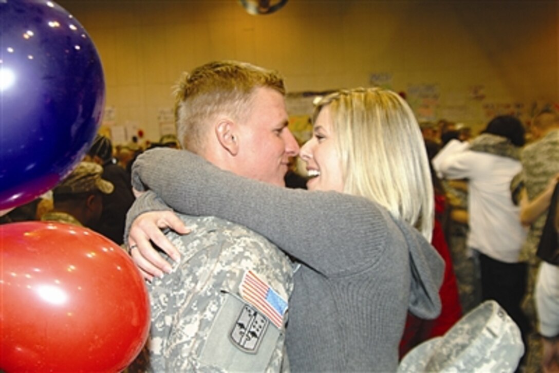 Sgt. Morgan Evans and wife Alana get reacquainted in Buckner Gym during 4th Battalion, 23rd Infantry Regiment's homecoming ceremony at Fort Richardson, Alaska, Nov. 25. The “Arctic Wolves” returned from a 16-month deployment to Iraq. 