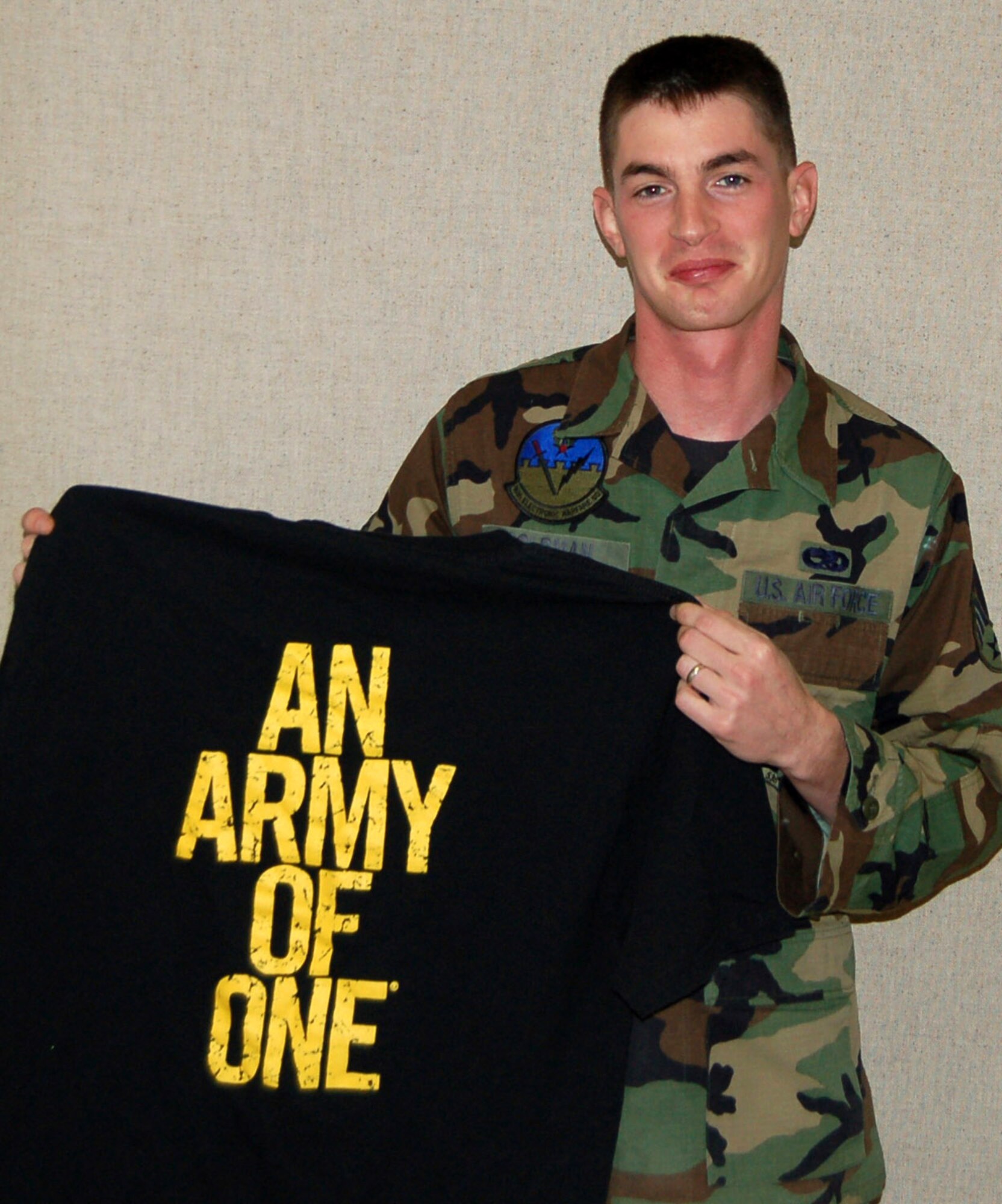 Senior Airman Mike Goldman displays an Army shirt that he will be wearing very soon.  Airman Goldman, a 16th Electronic Warfare Squadron journeyman at Eglin Air Force Base, Fla., is leaving the Air Force Dec. 29 to join the Army through "Operation Blue to Green" where he will become an operating room specialist.  (U.S. Air Force photo)