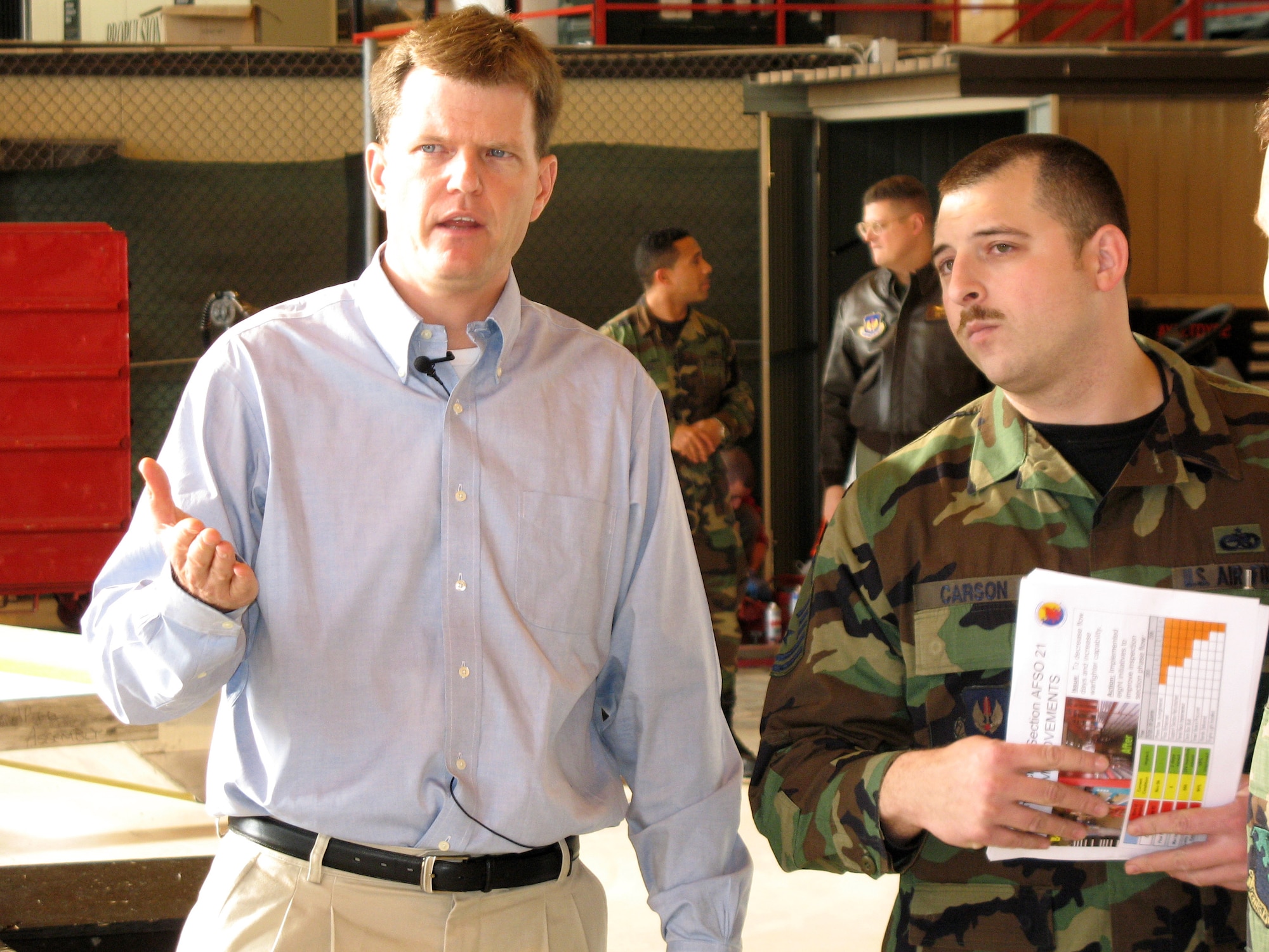 Dr. Ron Ritter, the secretary of the Air Force's special assistant for Air Force Smart Operations 21, speaks with Master Sgt. Ben Carson, Nov. 29, at the 31st Aircraft Maintenance Squadron hangar. He visited Aviano Air Base, Italy, Nov. 29 to see firsthand what improvements 31st AMX Airmen are making and how the improvements are being implemented. Sergeant Carson is the 31st AMX inspection chief. (U.S. Air Force photo)