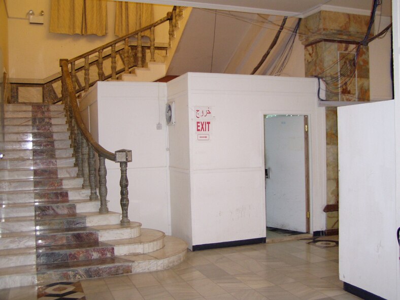 (Photo by Maj. Vince Cobb) A temporary office constructed of plywood stands in stark contrast to the ornate marble staircase and floor in the former presidential palace of Saddam Hussein. The palace now serves as the U.S. Embassy of Iraq.
