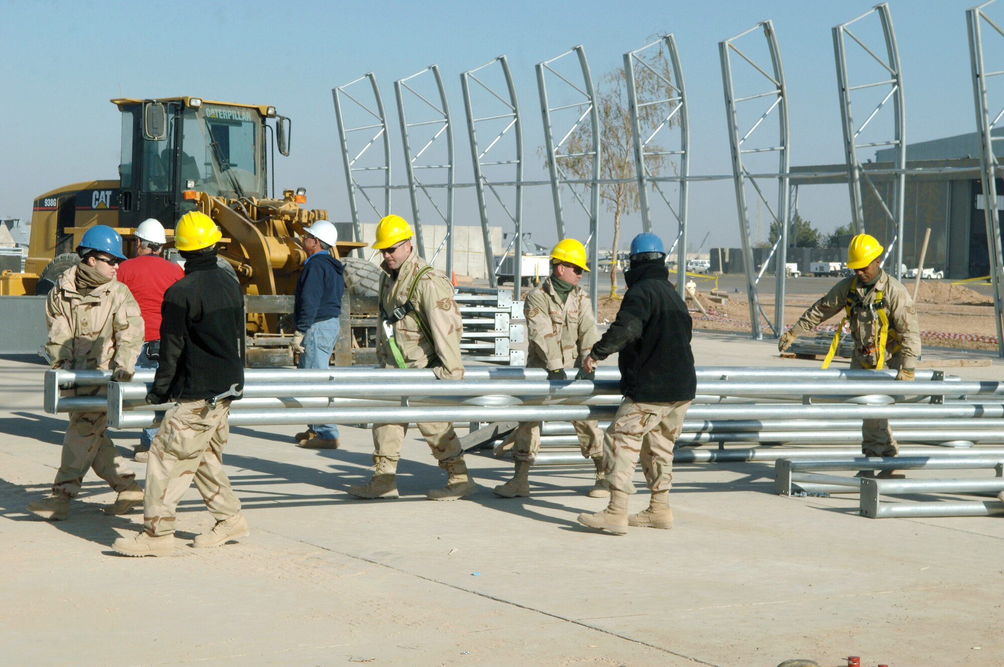 Airmen from the 332nd Expeditionary Civil Engineer Squadron Structures shop postion an arch Nov. 26 to the new Hunter Unmanned Aerial Vehicle shelter. The 20-day project at Balad Air Base, Iraq., will take approximately 3,200 man hours to complete. (U.S. Air Force photo/Airman 1st Class Chad M. Kellum) 
