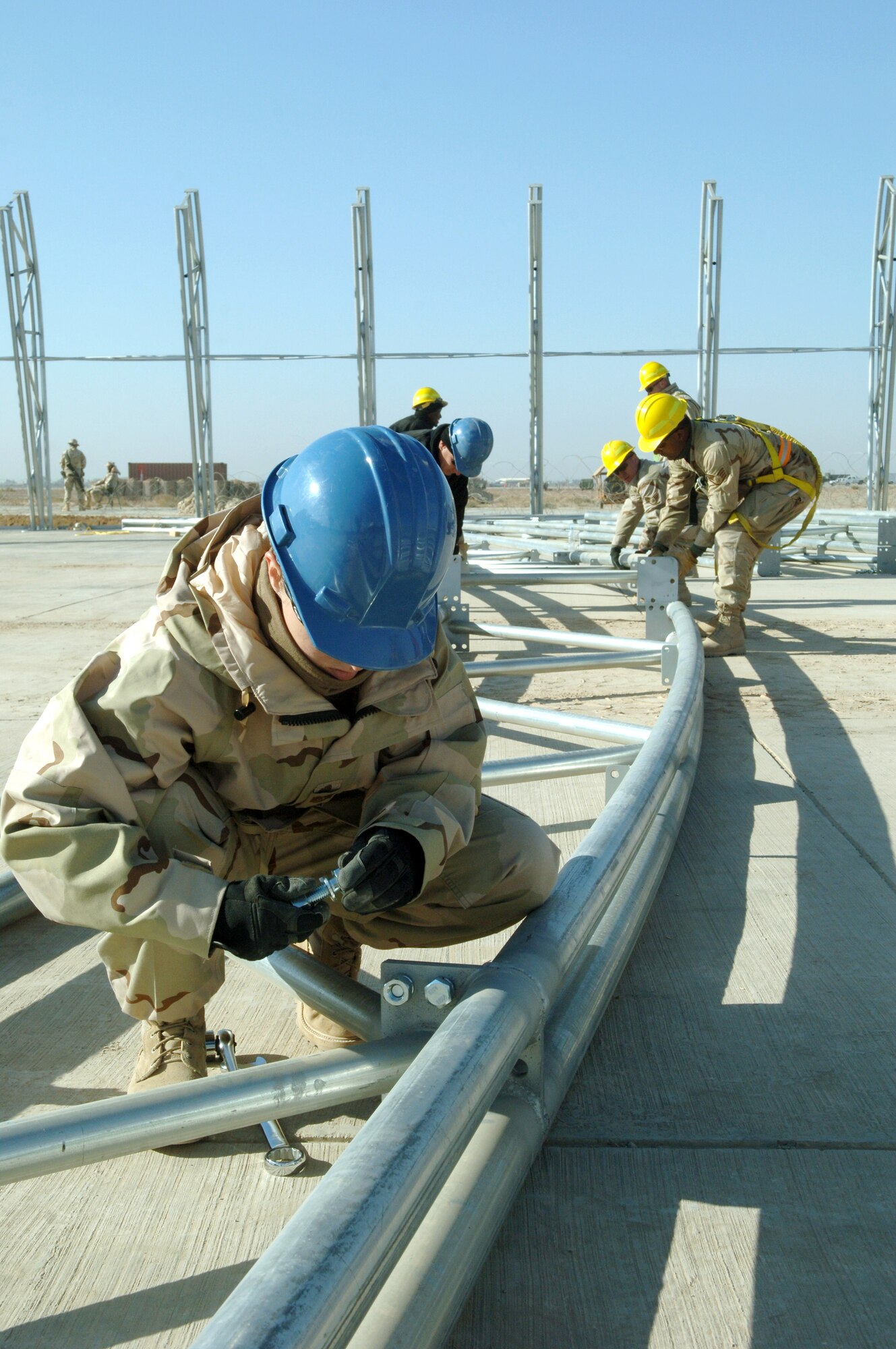 Technical Sergeant Wendy Hood, from the 332nd Expeditionary Civil Engineer Squadron Structures shop, adjusts a wrench to fit a bolt on an arch Nov. 26 for the new Hunter Unmanned Aerial Vehicle shelter. The 20-day project at Balad Air Base, Iraq., will take approximately 3,200 man hours to complete. (U.S. Air Force photo/Airman 1st Class Chad M. Kellum) 

