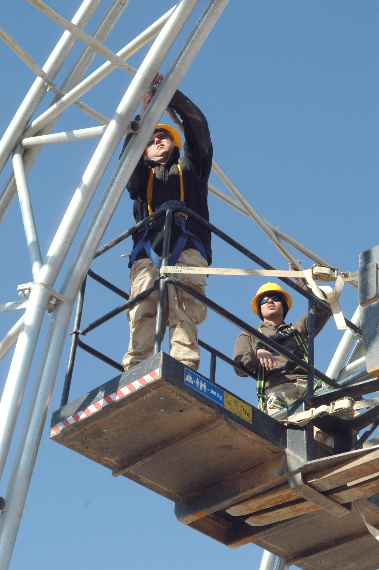 Senior Airman Brandon Braley and Airman 1st Class Andre Cervantes with the 332nd Expeditionary Civil Engineer Squadron Structures shop, attach a support beam to the new Hunter Unmanned Aerial Vehicle shelter arches Nov. 26. The 20-day project at Balad Air Base, Iraq., will take approximately 3,200 man hours to complete. (U.S. Air Force photo/Airman 1st Class Chad M. Kellum) 
