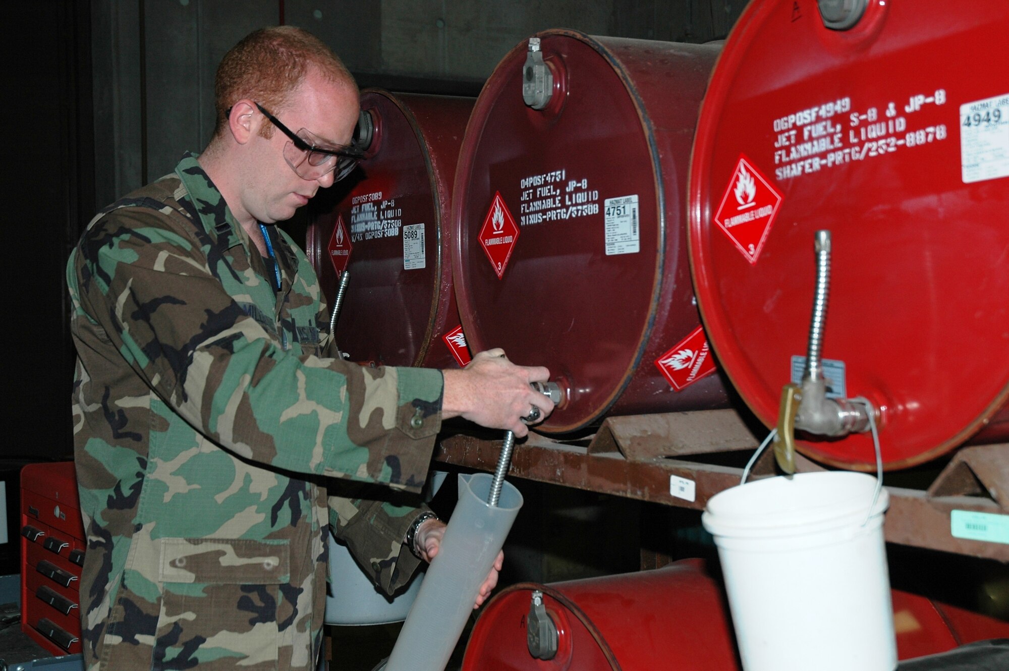 First Lt. Jeremiah Miller draws a fuel sample from jet fuel stocks at the Air Force Research Laboratory’s Propulsion Directorate for alternative fuels experiments. The lab is at the forefront of synthetic fuel research in support of the Office of the Secretary of Defense Assured Fuels Initiative. (Air Force photo by Adrian DeNardo) 