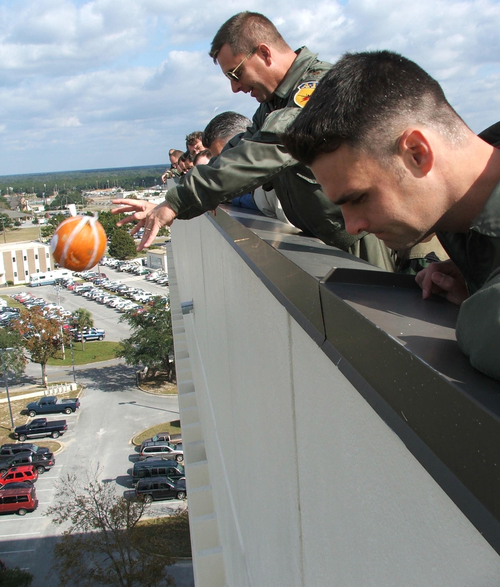 Maj. David Von Brock, 28th Test and Evaluation Squadron releases his JDAP from atop Building 350 Nov. 20.  Maj. Chris McCarthy, 28th TES, watches the drop. (Photo by Tech. Sgt. Andrew Leonhard)