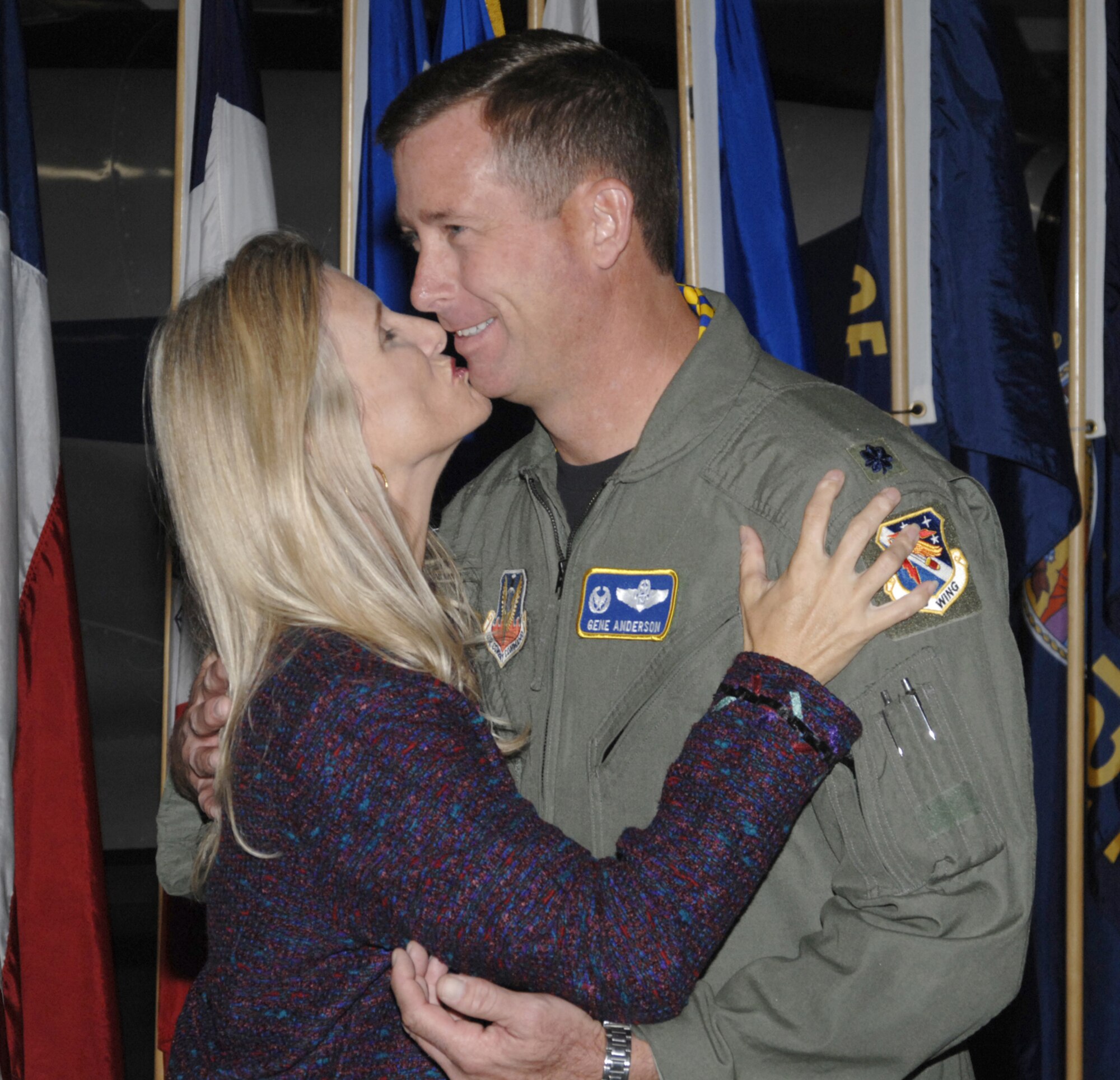 Lisa Anderson plants a smooch on her husband, Lt. Col. Gene Anderson, who took command of the 68th Electronic Warfare Squadron during the ceremony Nov. 16 at the Air Armament Museum.  Colonel Anderson  moved  up from Director of Operations with the 16th Electronic Warfare Squadron to take his first commander position. 