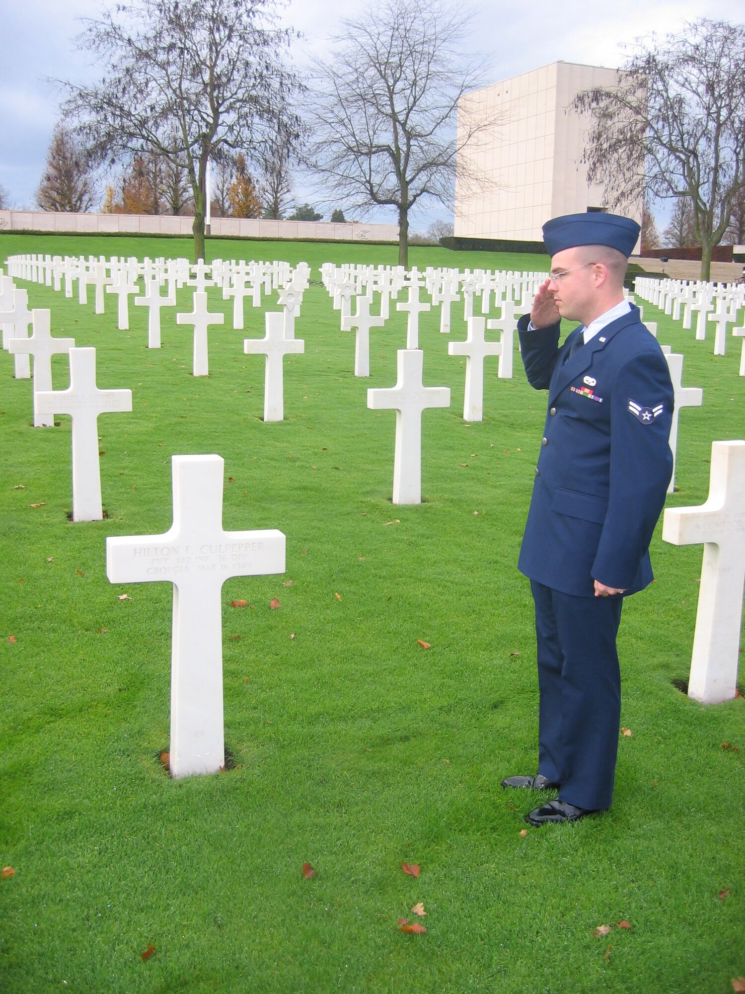 A1C Thomas Robertson, from the 1CBCS/CYBV, salutes his grandfather' grave at St. Avold Cemetery during the Lorraine Liberation Celebration. His grandfather was killed in the battles and buried there.
