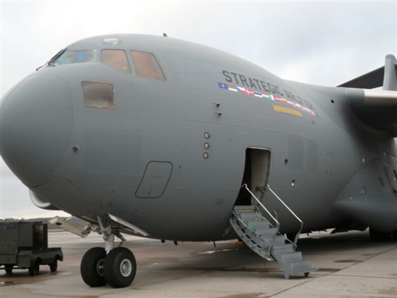 A C-17 sits on display in Riga, Latvia, where its capabilities were displayed Nov. 27 to NATO Secretary General Jaap de Hoop Scheffer, the president of Latvia, and senior alliance military officials – including Gen. Tom Hobbins, Allied Air Component Commander and U.S. Air Forces in Europe Commander. 
The cargo aircraft, flown to Latvia as part of the Riga Summit by aircrew members from the 62nd Airlift Wing at McChord Air Force Base, Wash., showcased a joint initiative by 15 NATO member countries and partner country Sweden to purchase C-17 transport aircraft in order to provide strategic airlift capability for NATO and other missions, according to a NATO news release.
The capability will initially comprise three C-17s, flown and maintained by multinational aircrews under the command of a multinational military structure.
The aircraft will be used for missions which may be purely national in character but could also be allocated to NATO operations or for United Nations, European Union or other international purposes such as humanitarian relief.