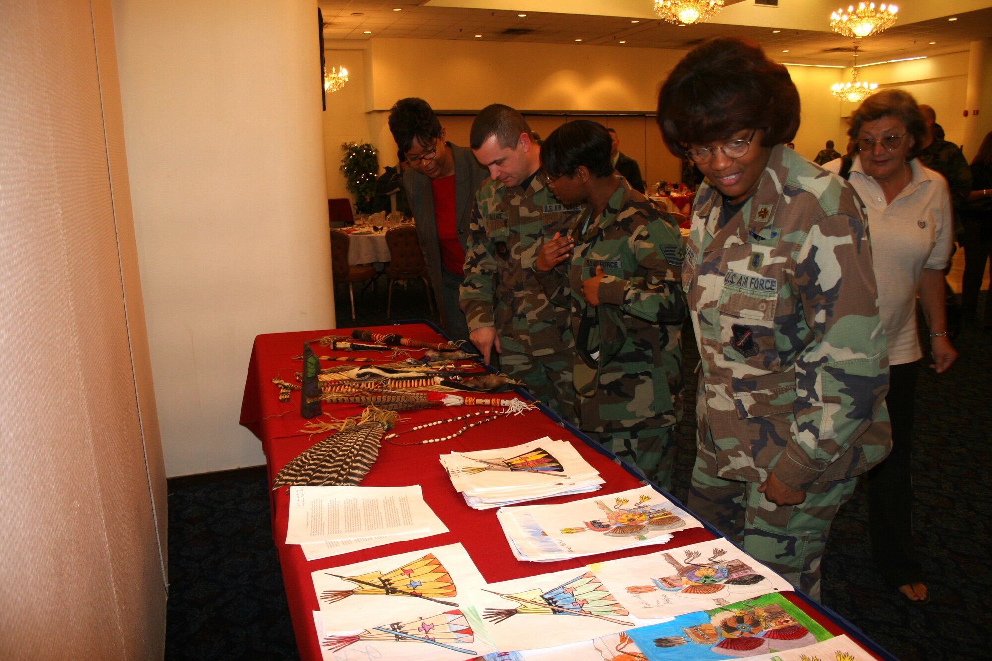 Base members look at different Native American displays at the Consolidated Club here Nov. 28, after the Native American Heritage Luncheon. More than 60 people attended the luncheon. Airman 1st Class Amber Kitto, 39th Logistics Readiness Squadron HAZMAT supply technician, gave auidence members an insight into Native American culture from dream catchers to the eagle feathers. (U.S. Air Force photo by Senior Airman Patrice Clarke)