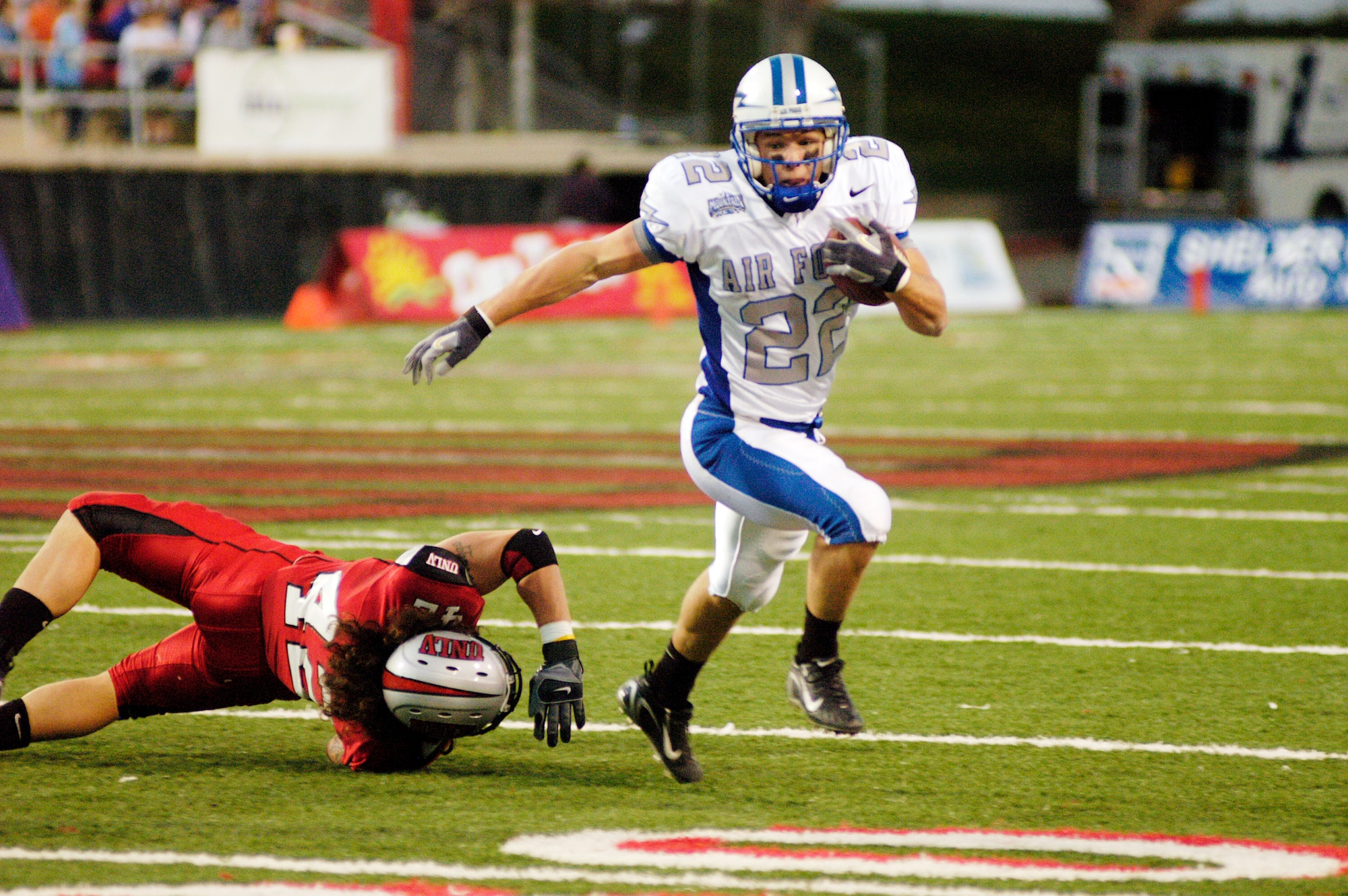Falcons halfback Beau Suder, 22, eludes the tackle of University of Nevada-Las Vegas defensive back Jay Staggs during the Air Force's 42-39 loss Nov. 24 in Las Vegas. Suder finished the game with 20 yards on three carries and a 20-yard touchdown reception. (U.S. Air Force photo/Cadet 2nd Class Paul Russo)