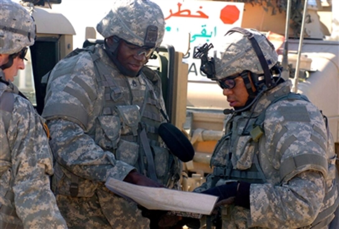 U.S. Army Staff Sgt. Mendez Frith, 1st Platoon, Bravo Battery, 1st Battalion, 7th Field Artillery, 2nd Brigade Combat Team, 1st Infantry Division, briefs his troops before heading out on the streets of Baghdad, Nov. 26, 2006.