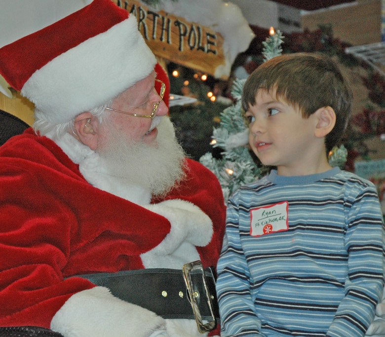 EIELSON AIR FORCE BASE -- Ryan Lamoureux, son of Tech. Sgt. Grace Lamoureux, 354th Communications Squadron, informs Santa of his Christmas wishlist. Top on the list - "Thomas the Train." More than 30 children were selected for the first-ever Top of the World Toy Summit at the Santa Claus House in North Pole, Alaska. (U.S. Air Force photo by Senior Airman Justin Weaver). 