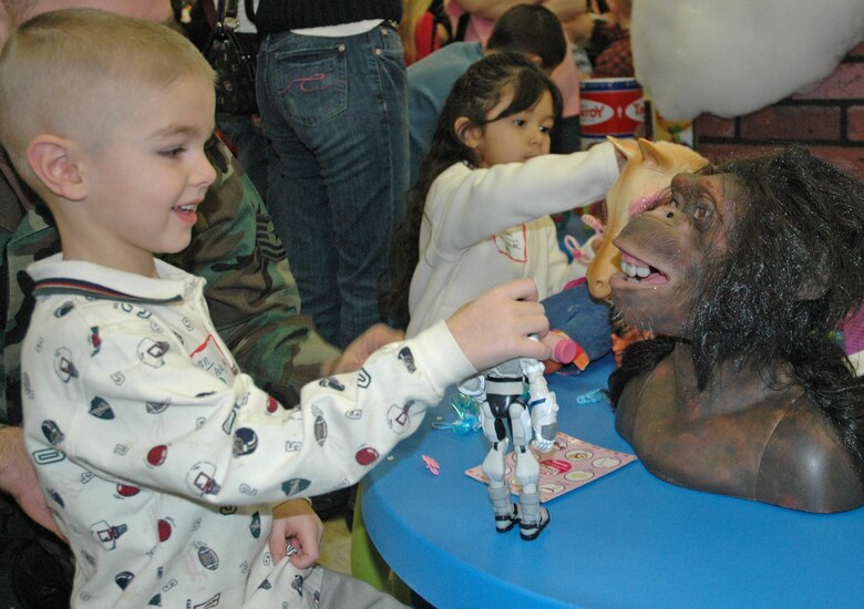 EIELSON AIR FORCE BASE -- Evan Dorschner, son of Shannon and Tech. Sgt. Jeremy Dorschner, plays with the latest and hottest toys of the Christmas season. More than 30 children were selected for the first-ever Top of the World Toy Summit at the Santa Claus House in North Pole, Alaska. (U.S. Air Force photo by Senior Airman Justin Weaver). 