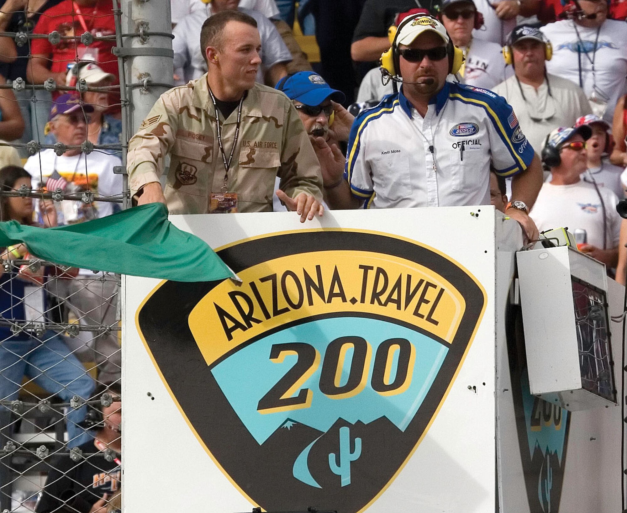 Ready, set, green-green-green!
Senior Airman Skyler Posey, 56th Electronic Maintenance Squadron aircraft metals technician, waves the green flag to start the NASCAR Busch Series race Saturday at the Phoenix International Raceway in Avondale. Airman Posey was selected to start the race, had the opportunity to meet the drivers prior to the race and presented the trophy to the race winner in victory lane.  Photo by Tech. Sgt. Frank Hatcher