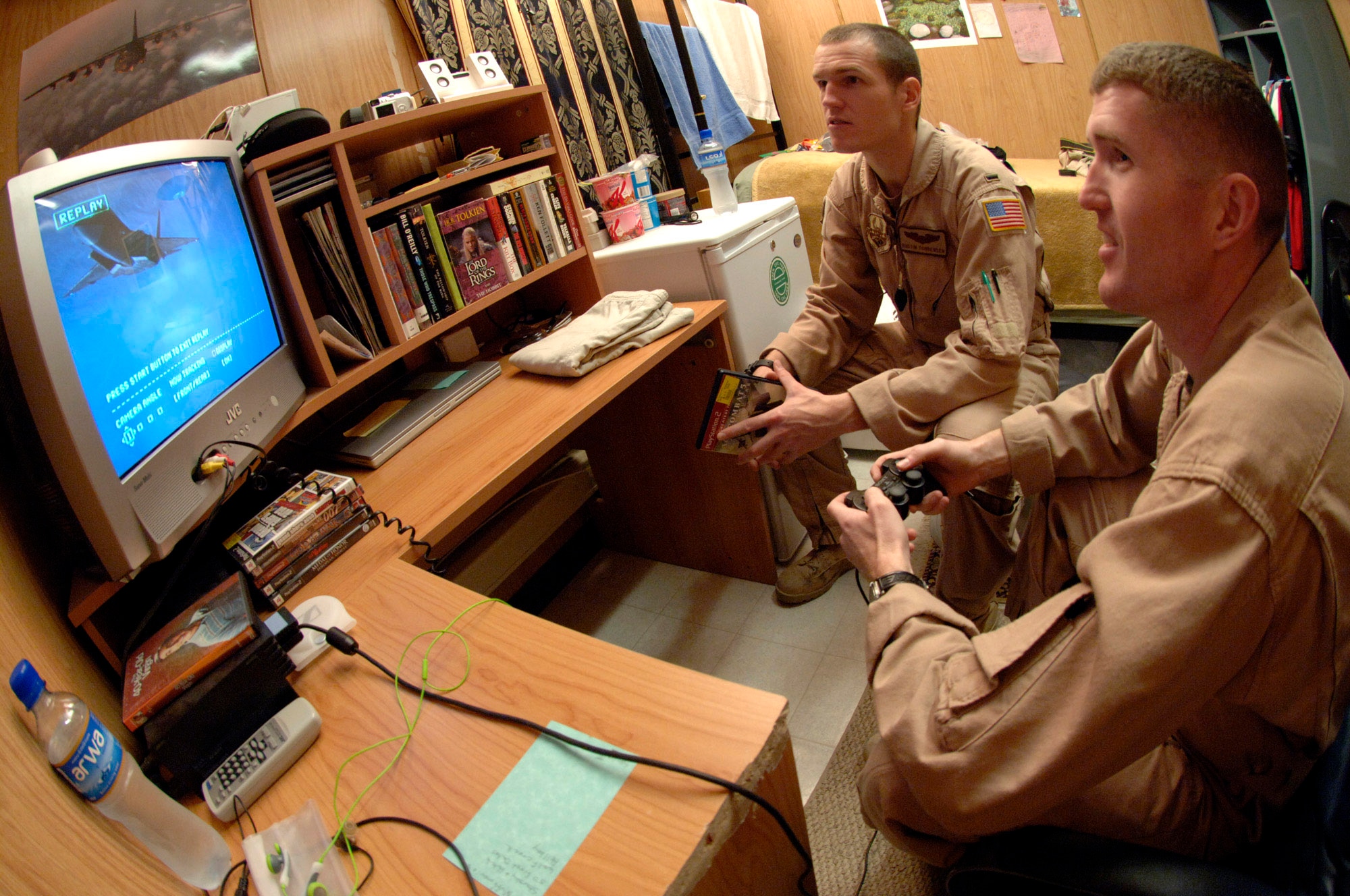 Marine Capt. Jason Torbensen shares off-duty time with his younger brother, Air Force 1st Lt. Dustin Torbensen in his dormitory room Nov. 28 at a forward-operating base in Southwest Asia. Captain Torbensen is deployed for one year in Southwest Asia as the 3rd Marine Airlift Wing's liaison officer to the Combined Air Operations Center, and Lieutenant Torbensen is soon to return from a two-month rotation to Southwest Asia. The brothers are from Kaysville, Utah. (U.S. Air Force photo/Master Sgt. Scott Wagers) 