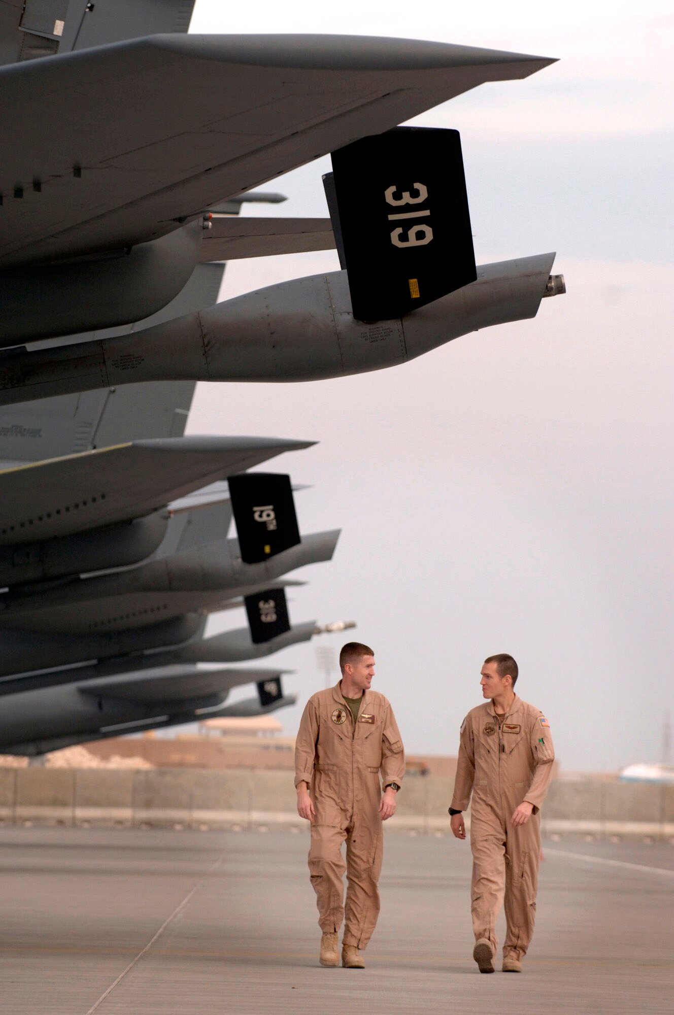 Marine Capt. Jason Torbensen visits the flightline where his younger brother, Air Force 1st Lt. Dustin Torbensen parks his KC-135 Stratotanker Nov. 28 in Southwest Asia. Captain Torbensen is deployed for one year in Southwest Asia as the 3rd Marine Airlift Wing's liaison officer to the Combined Air Operations Center, and Lieutenant Torbensen is soon to return from a two-month rotation to Southwest Asia. The brothers are from Kaysville, Utah. (U.S. Air Force photo/Master Sgt. Scott Wagers) 
